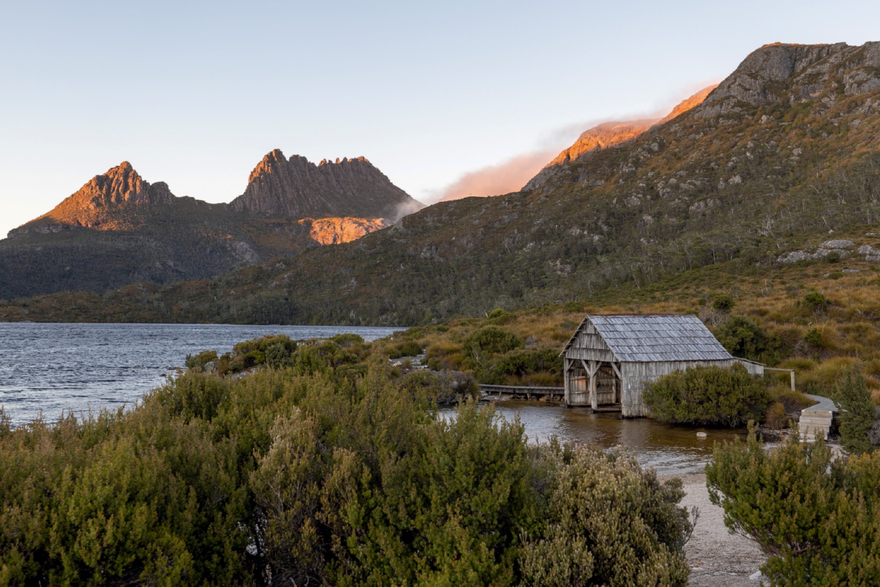 a boatshed on a lake