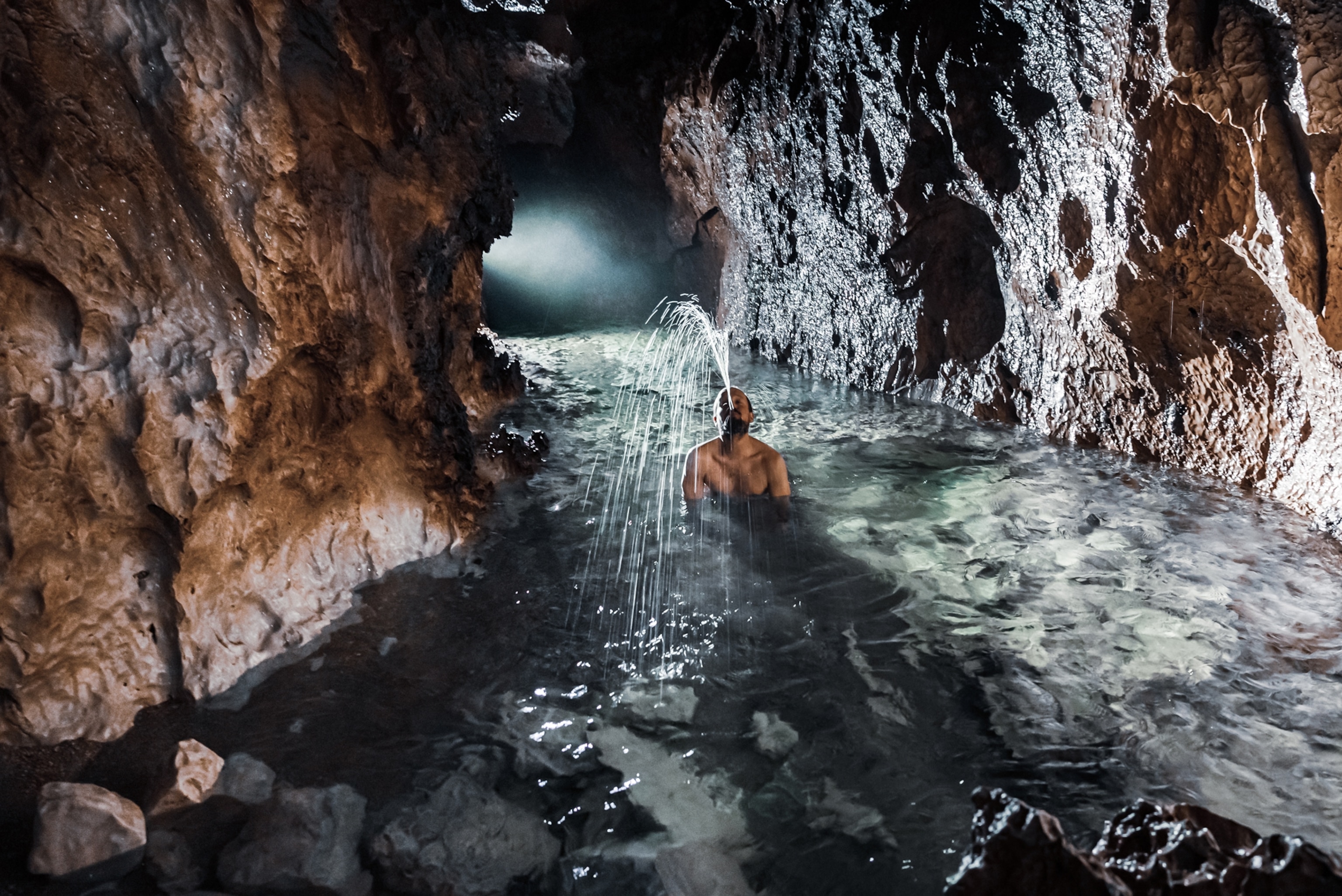 Picture of man in cave river