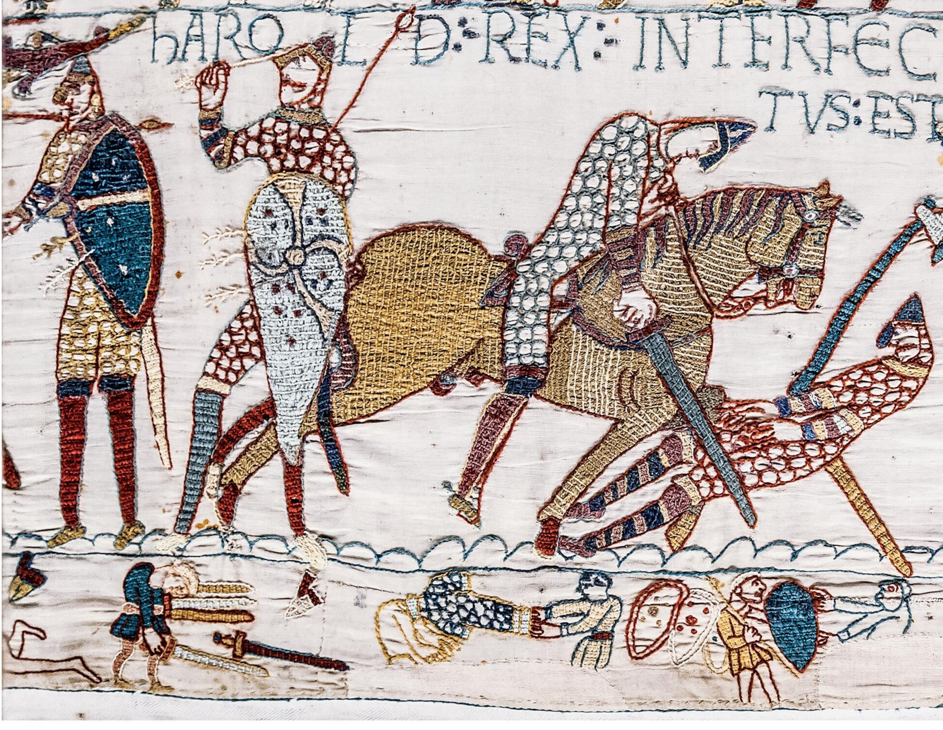 Colorful thread ebroidered in the shapes of soldiers on a white fabric.