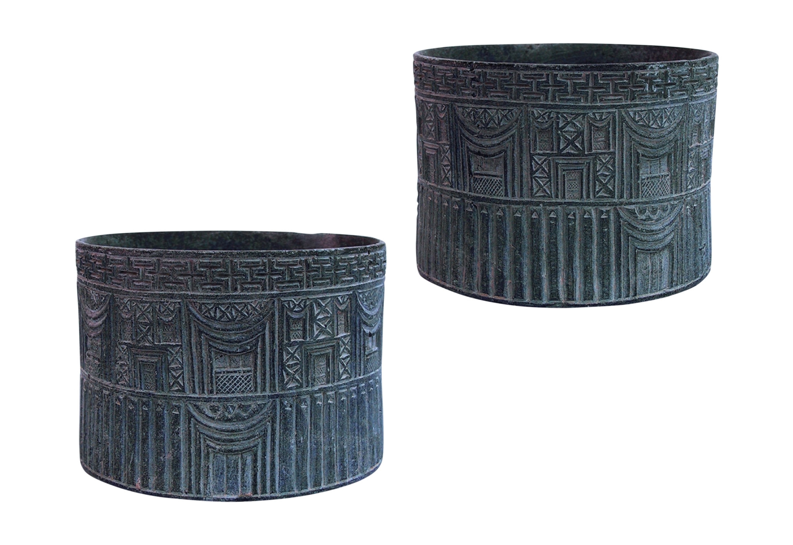 A cylinder with the outside of a building carved on it