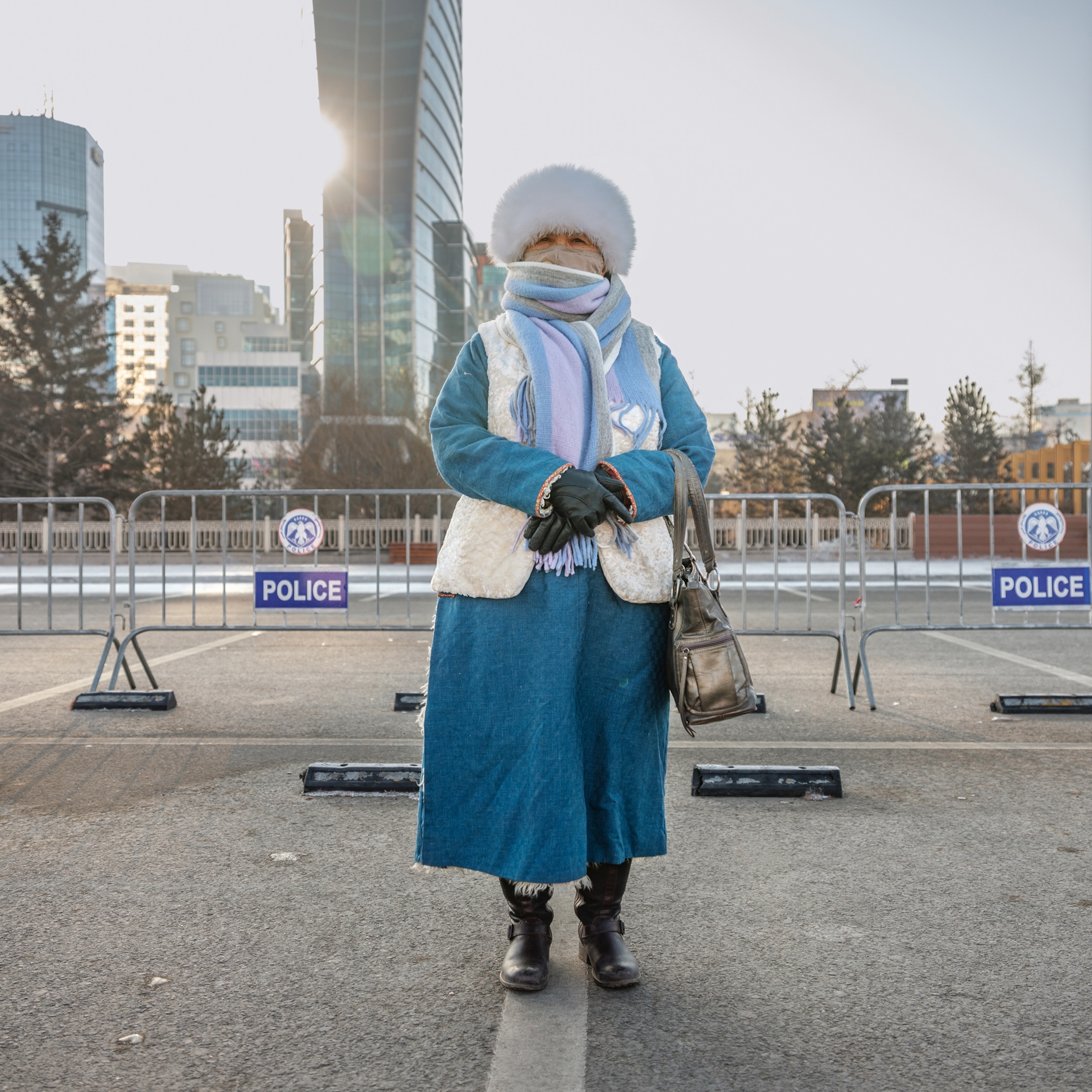Picture of a woman in blue winter coat and fur.