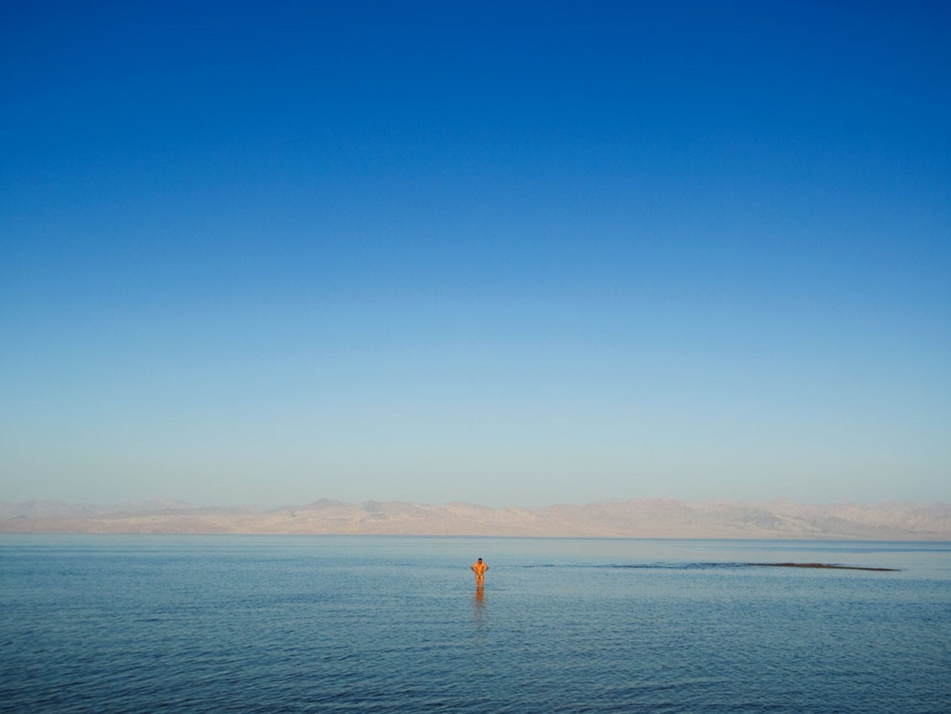 A man standing in a shallow sea