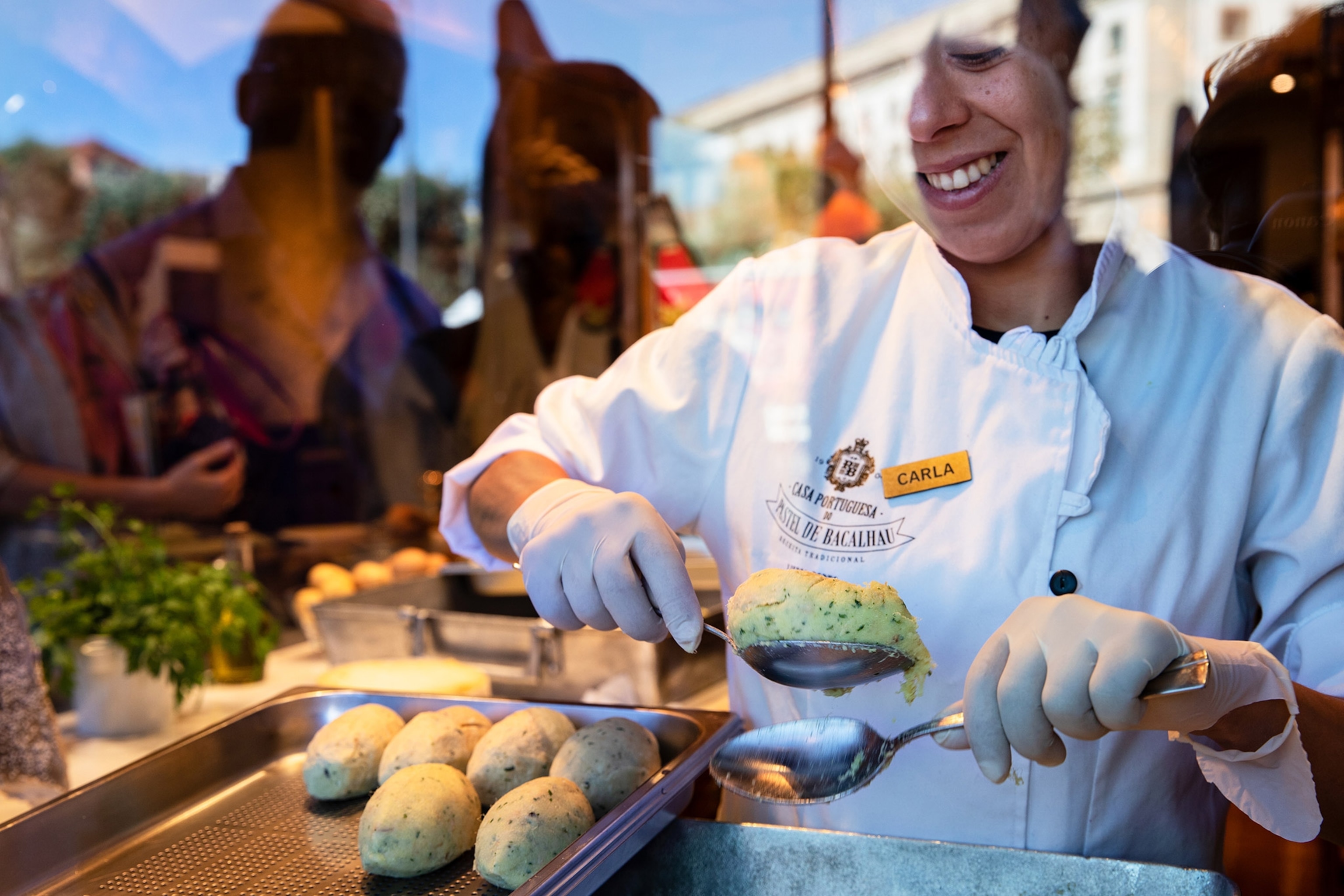 chef creating fish balls at casa portuguesa pastel de bacalhau in porto, portugal