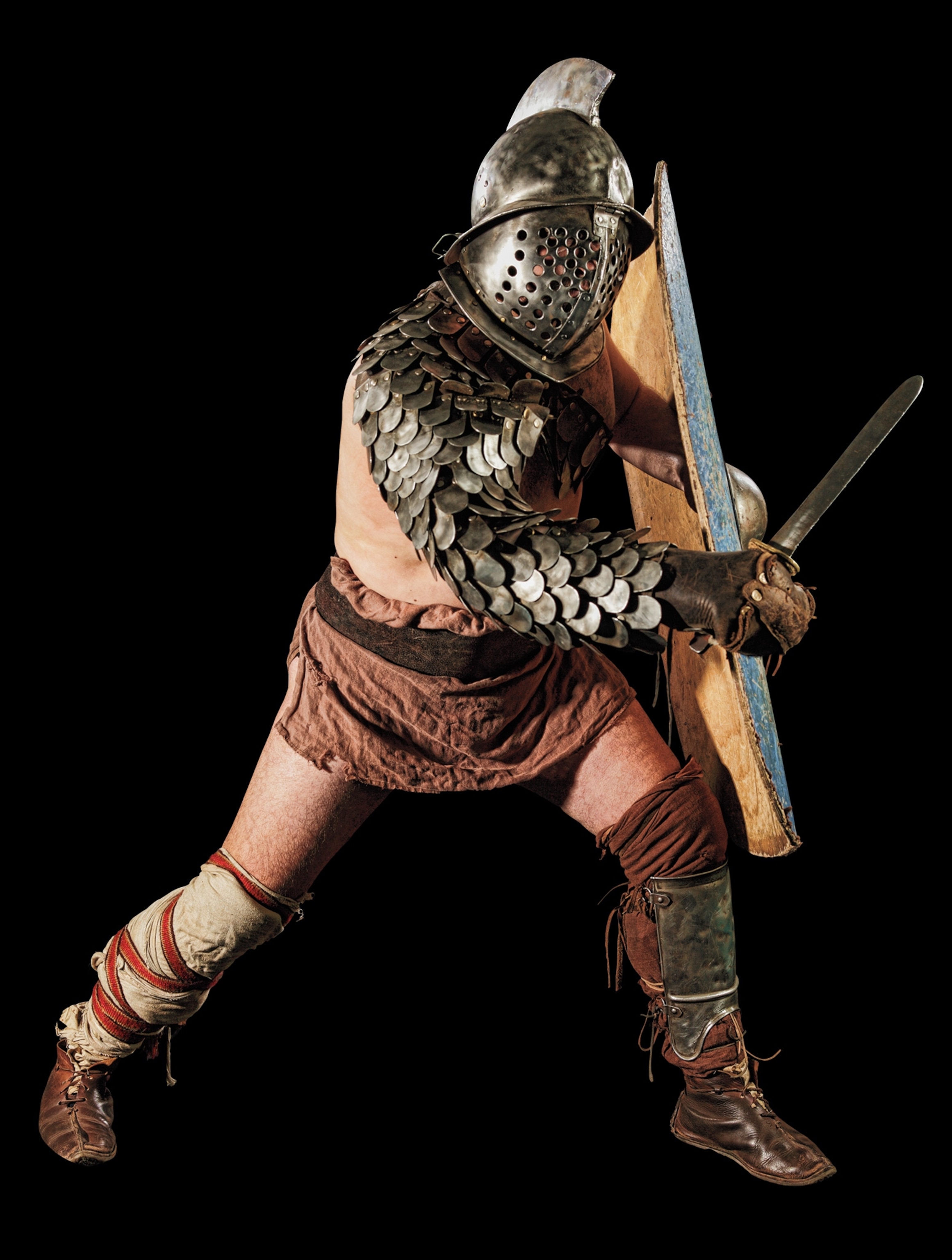 The tank of the arena, this gladiator carried a shin-to-shoulder shield, wore a heavy, full-coverage helmet topped with a tall crest, and donned arm and leg guards into the arena. He was armed with a short sword, called a gladius, based on the standard weapon of Roman legionaries.