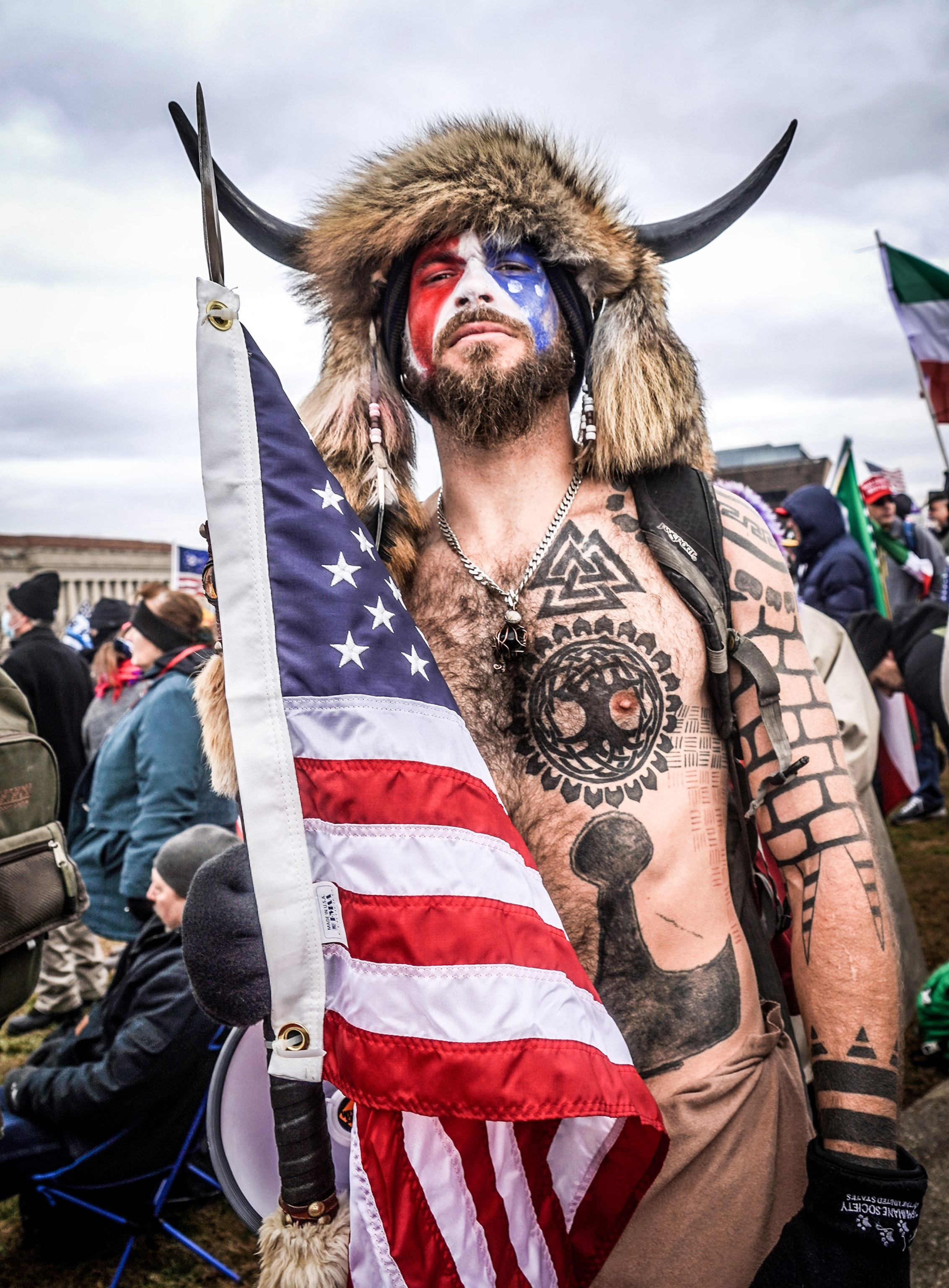 Jake Angeli, a QAnon supporter known for his painted face and horned hat outside the US Capitol