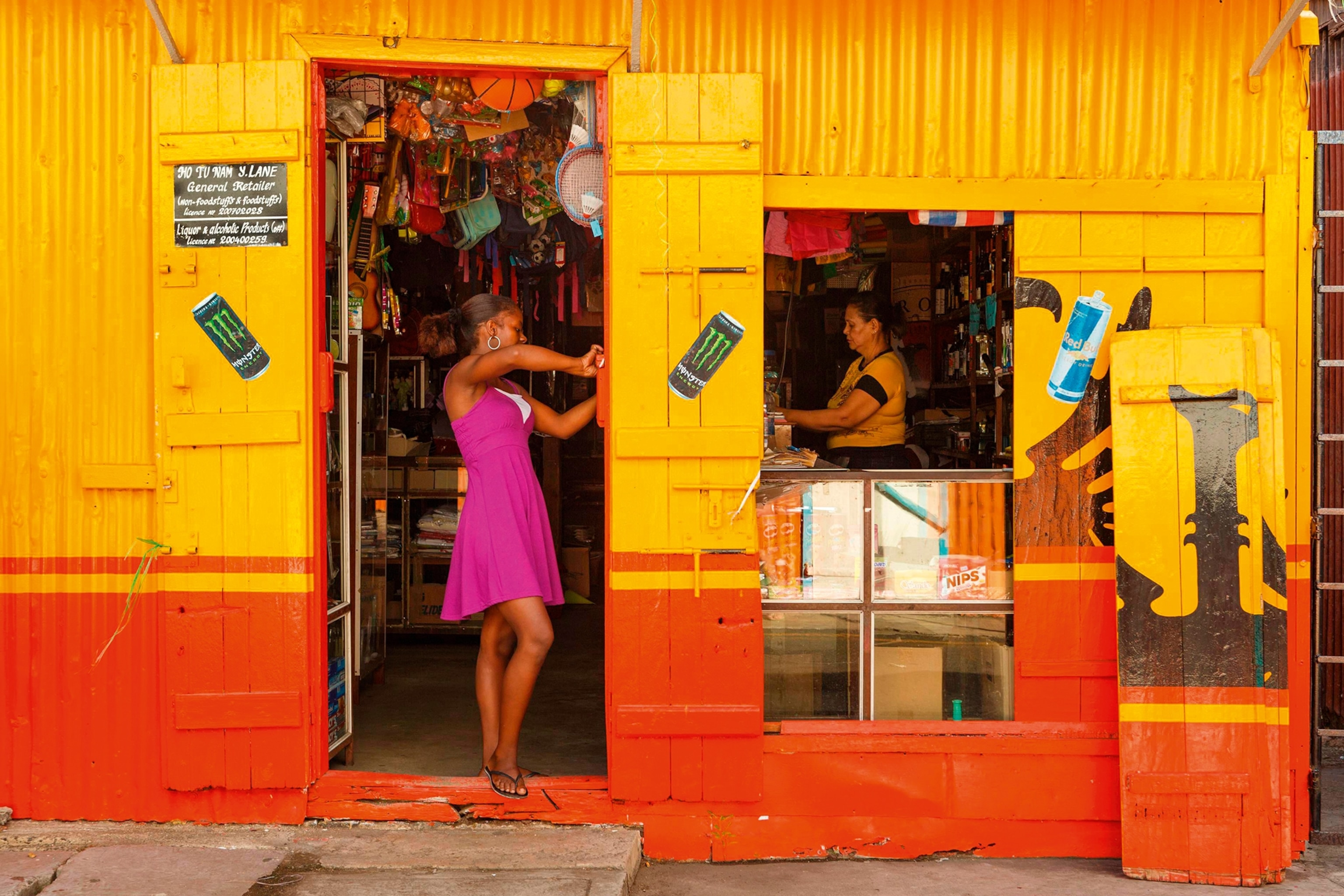 two women in the doorway and window of a shop