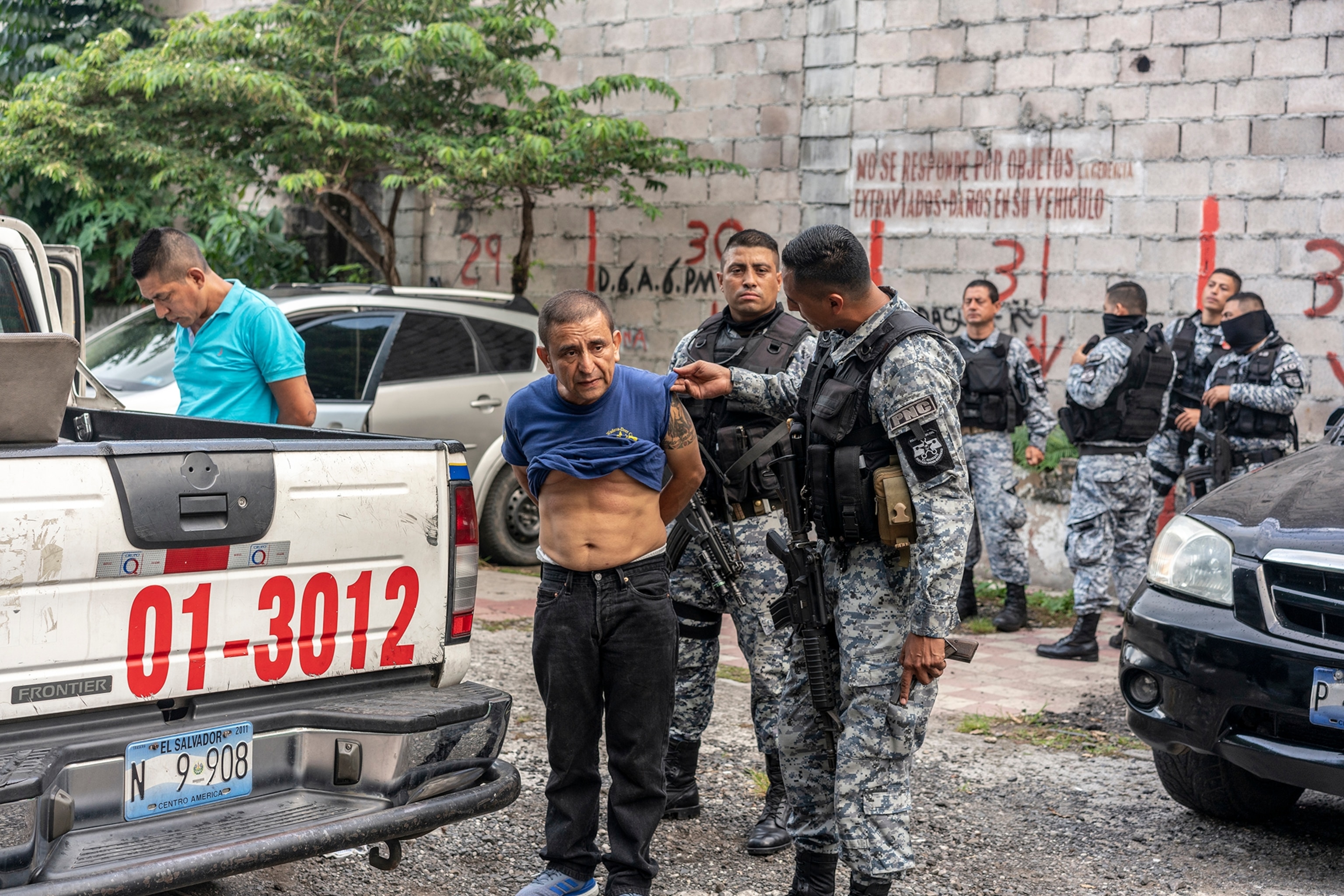 a police checking the arm of a man