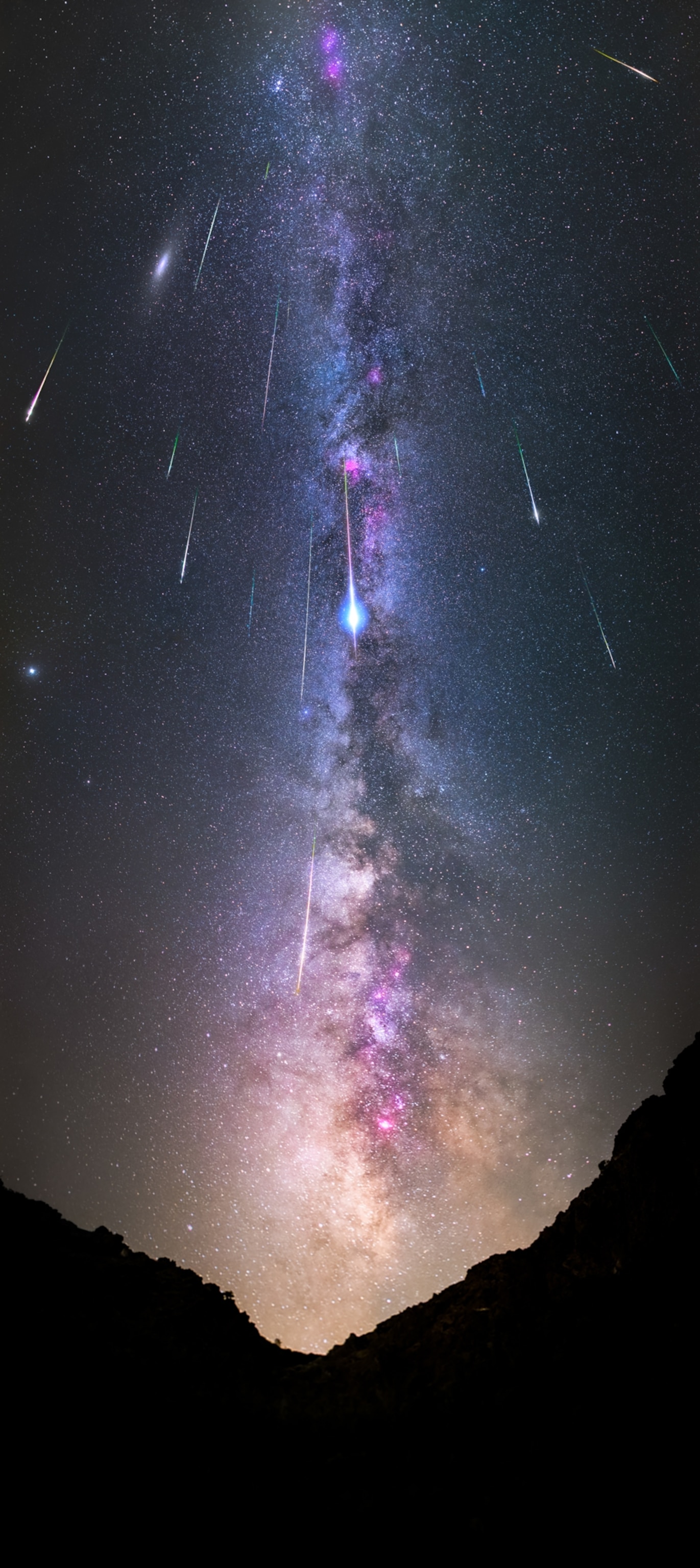 Several bright streaks of light against a brilliant backdrop of the Milky Way.