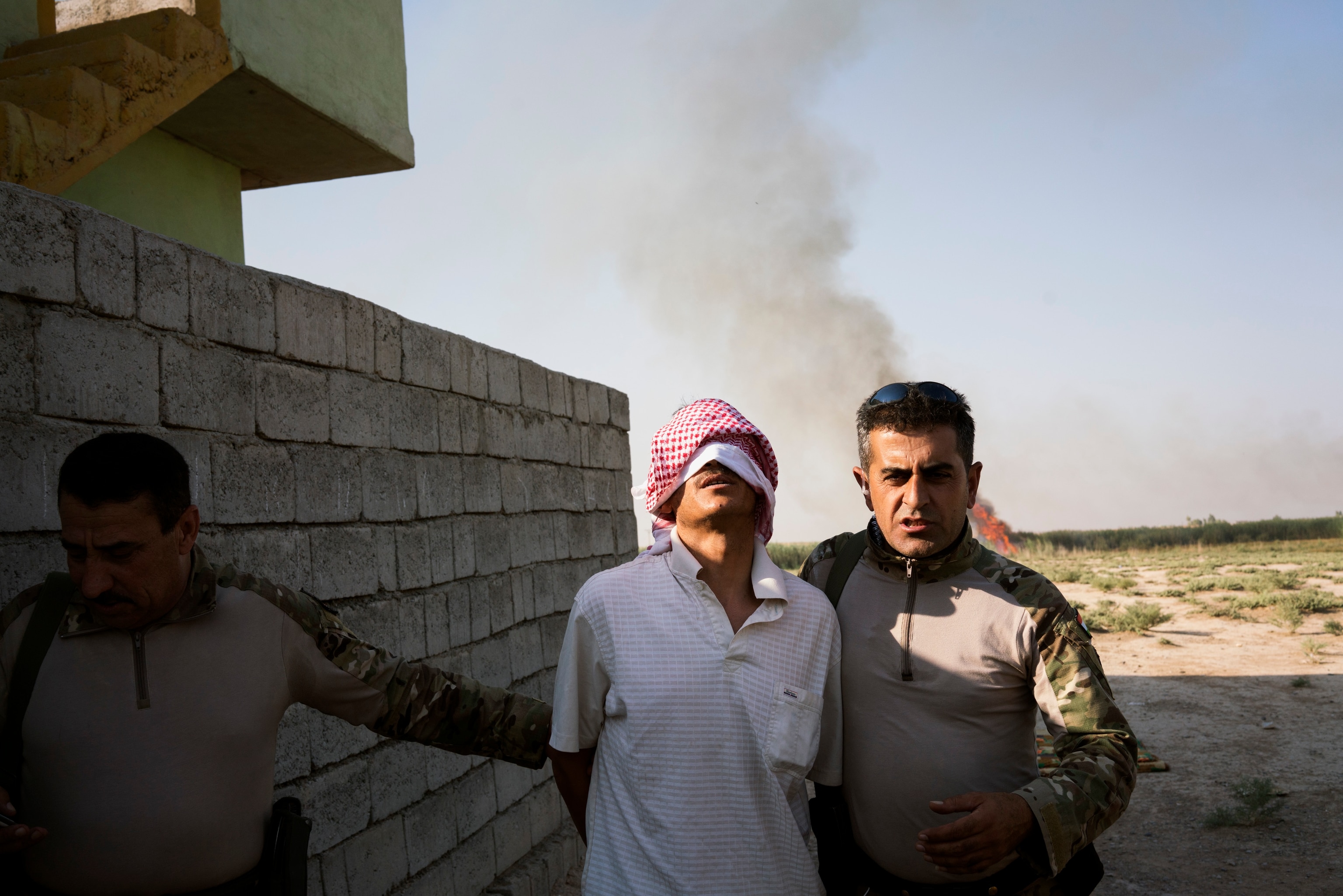 an ISIS sympathizer who has been arrested and blindfolded