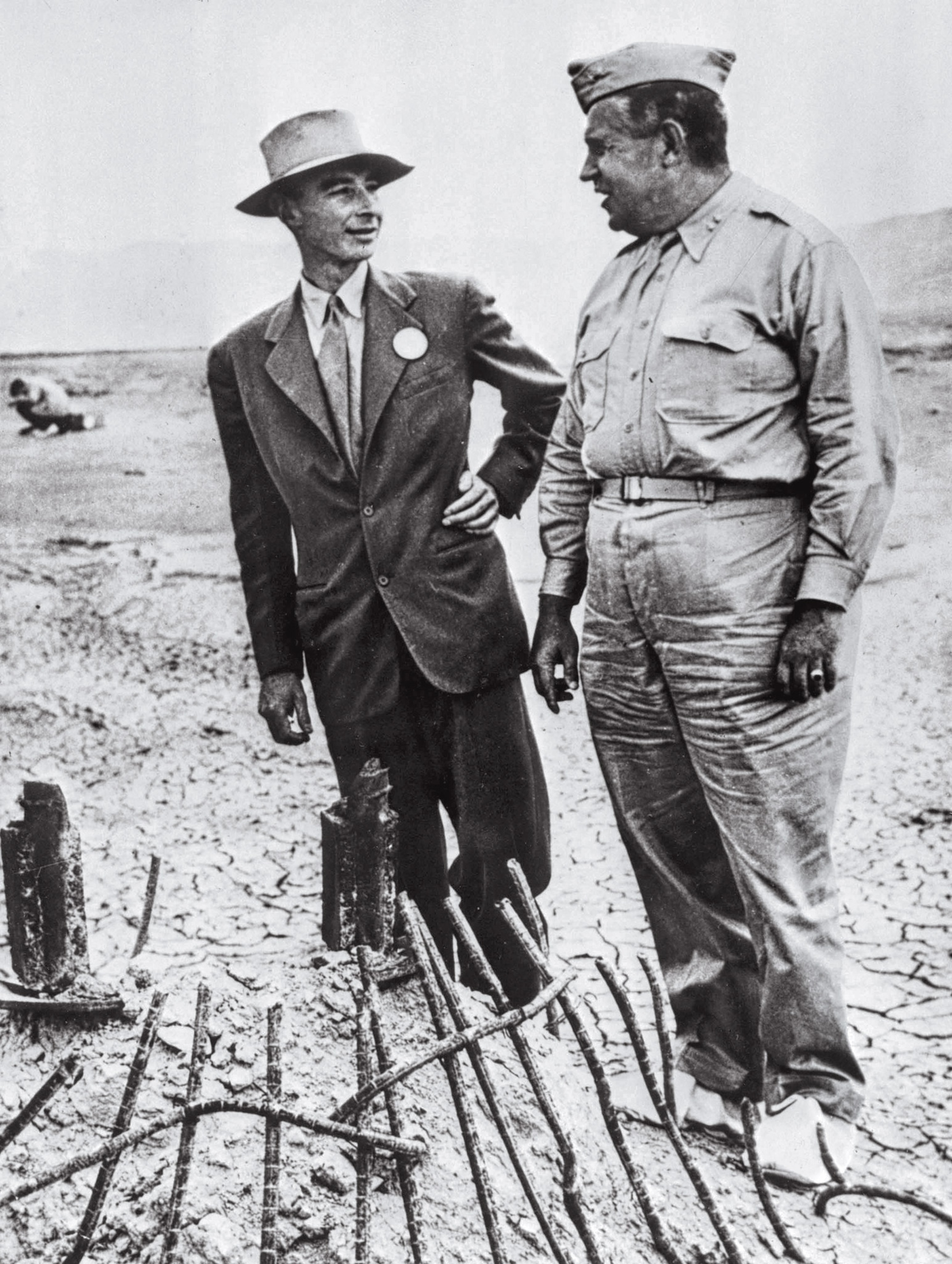 Two man stand next to each other having a discussion.