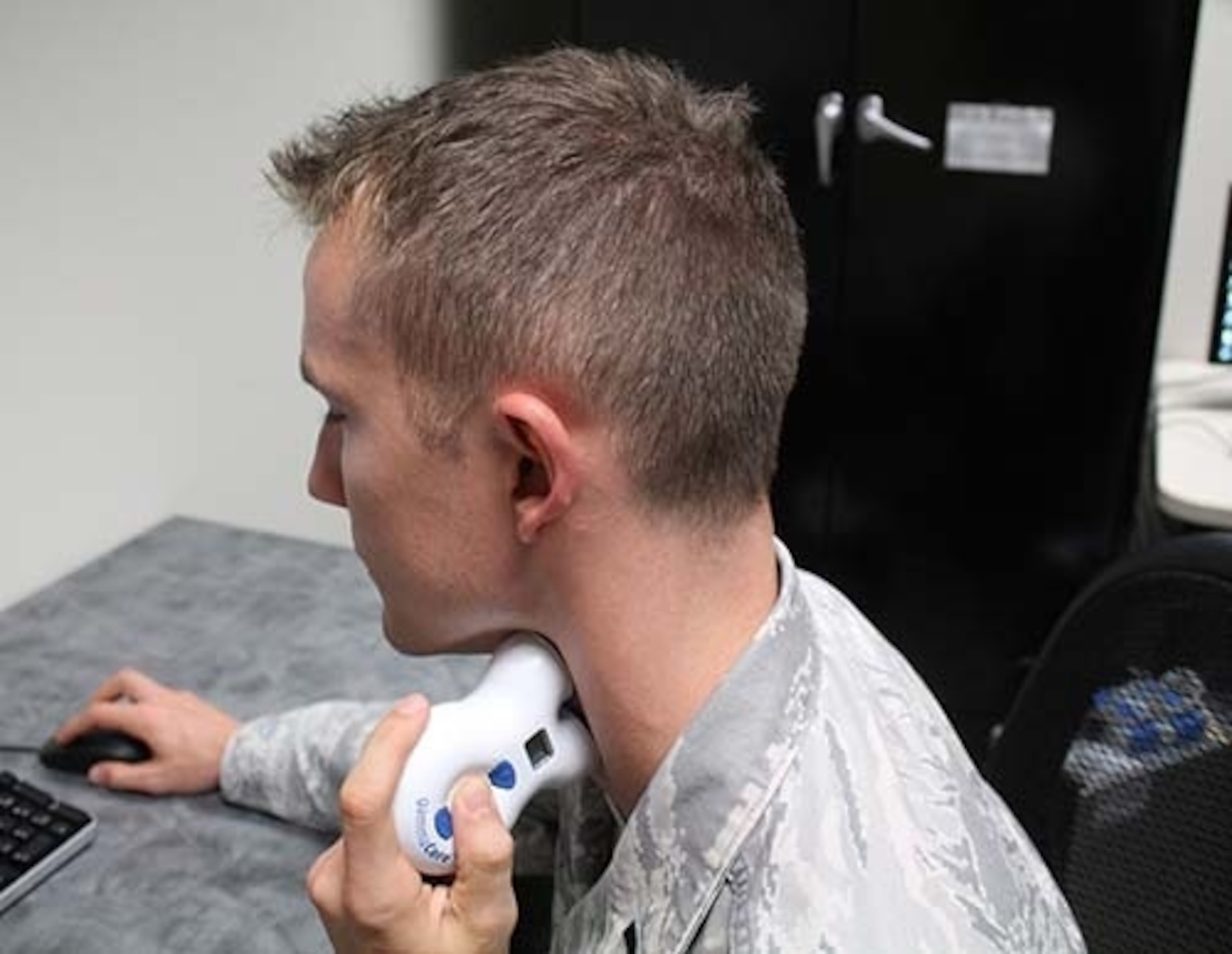 A man holding device to his neck