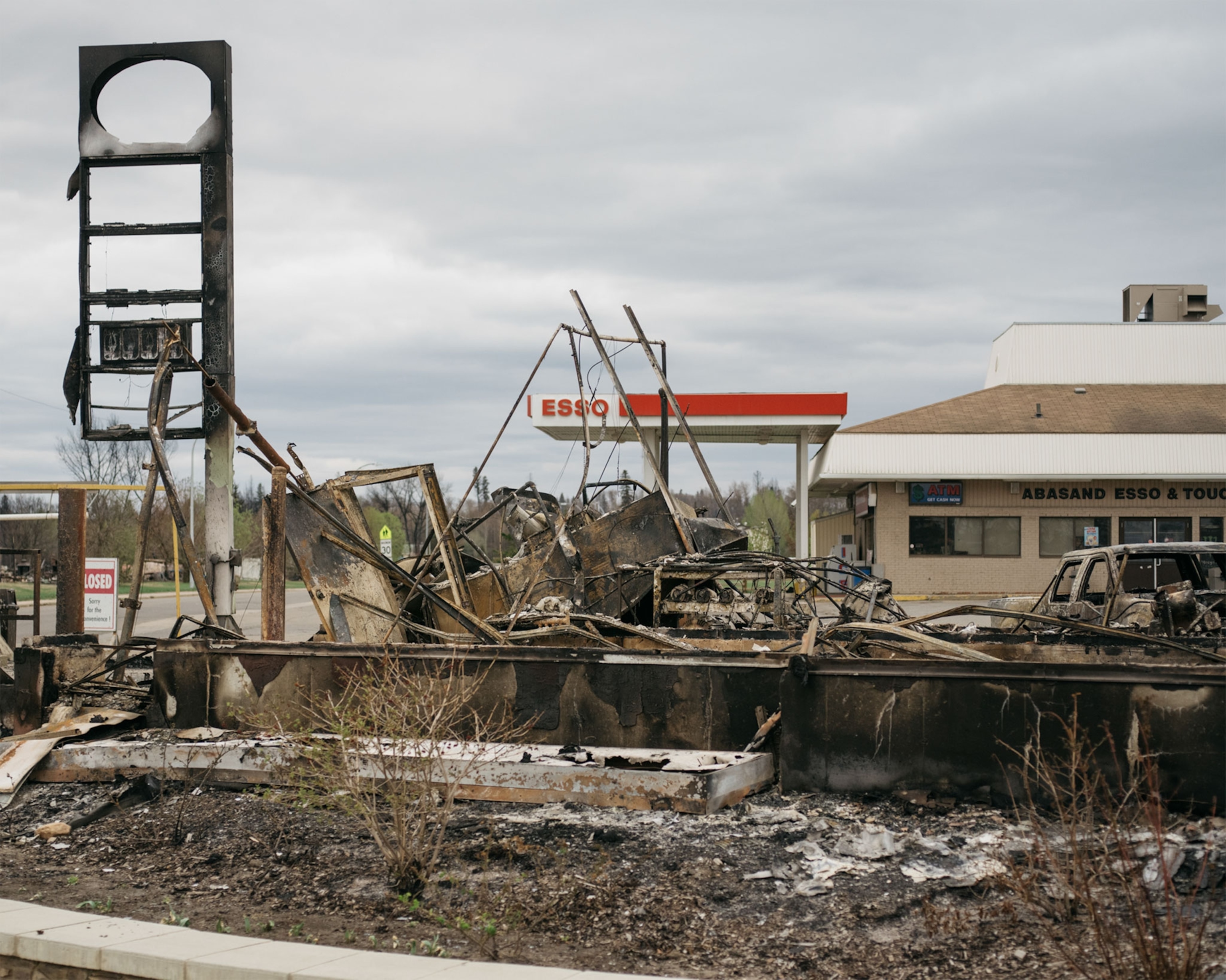 a burned down building near a gas station in Alberta, Canada