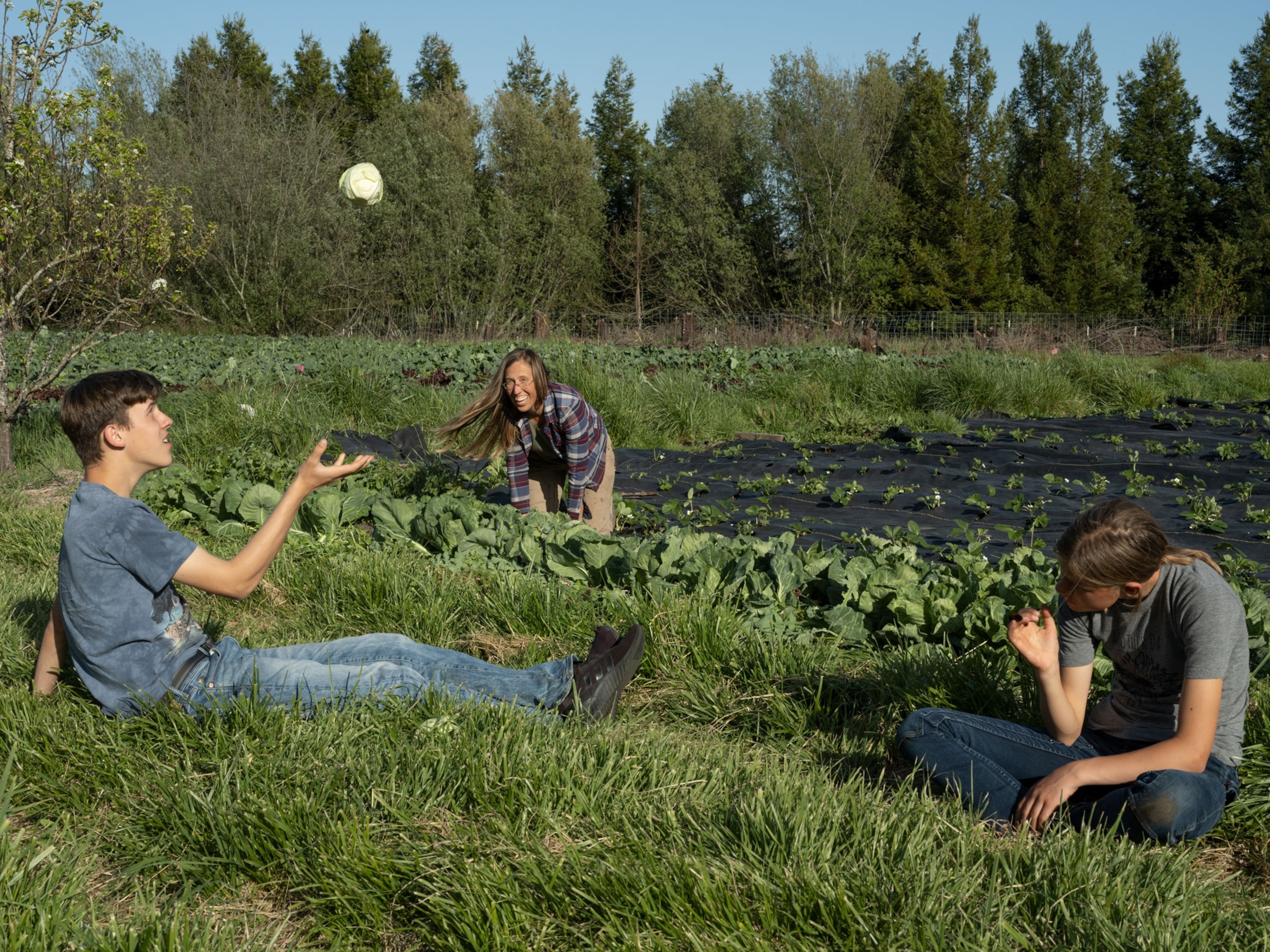 Family sits in the farm bed.