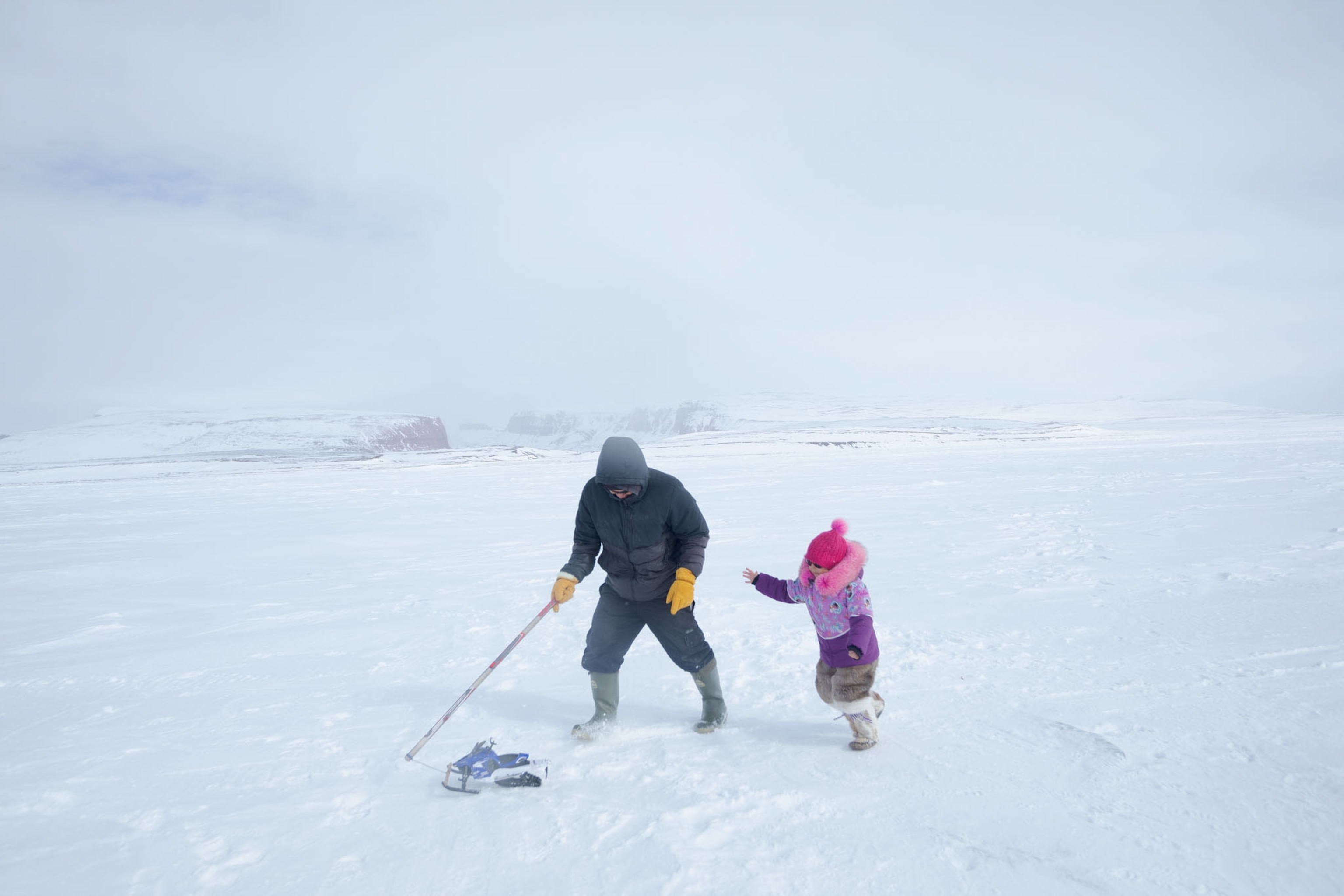 a father and daughter playing on a family camping trip in the Canadian High Arctic