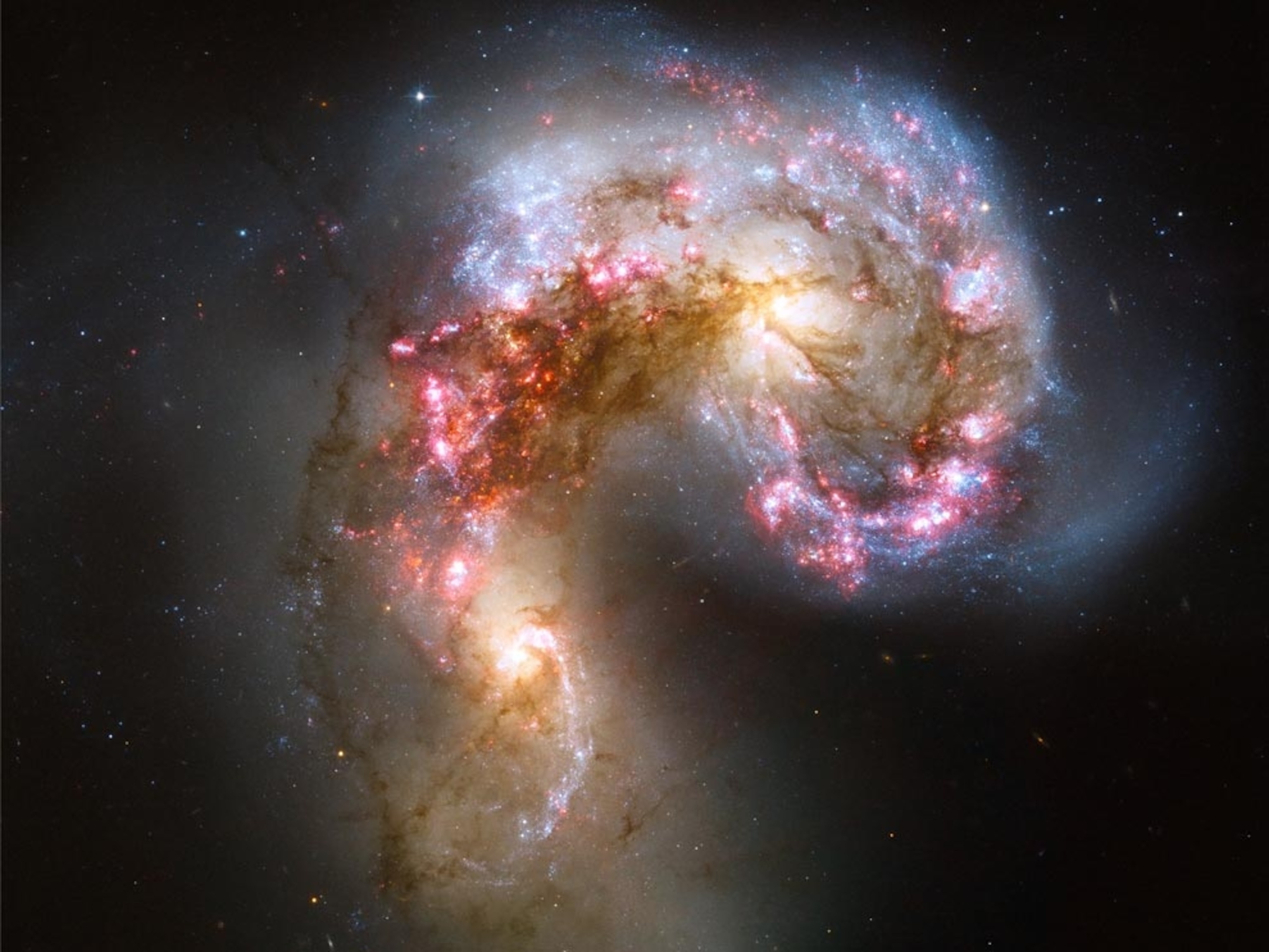 a pair of glowing, merging galaxies
