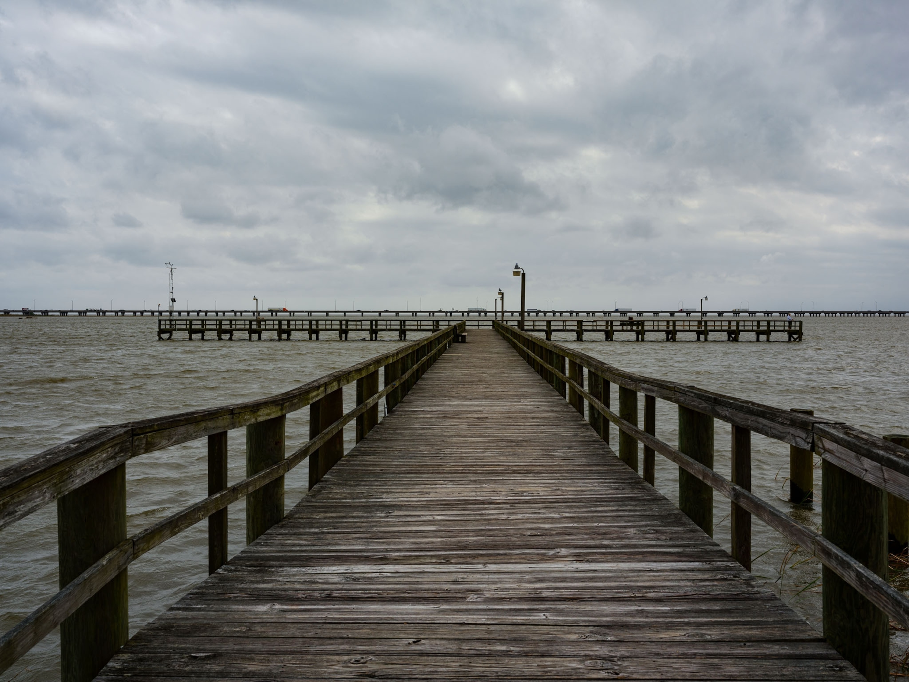 a wood dock leading into a river