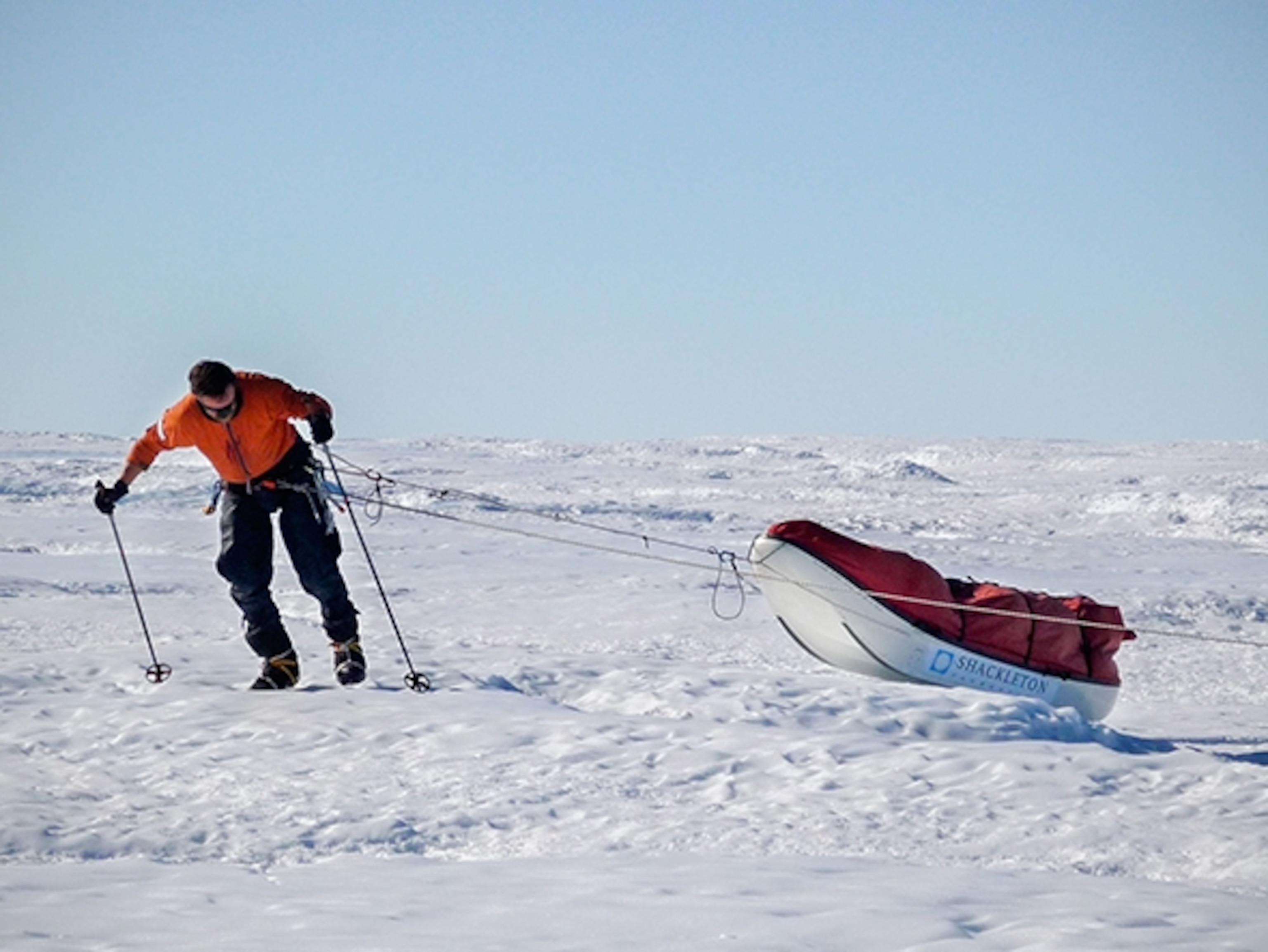 a man pulling a sled