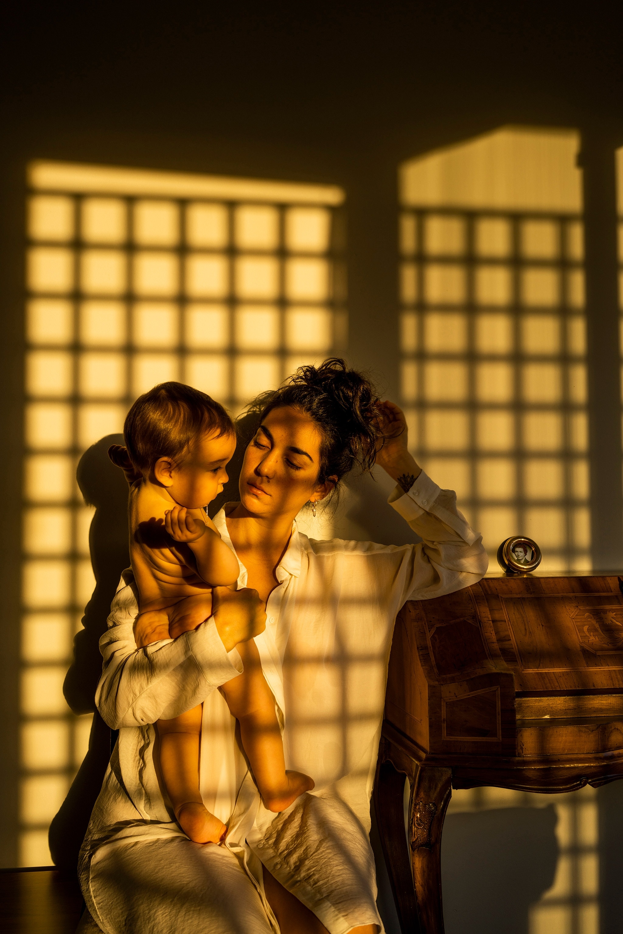 a mother holding her child in the sunlight