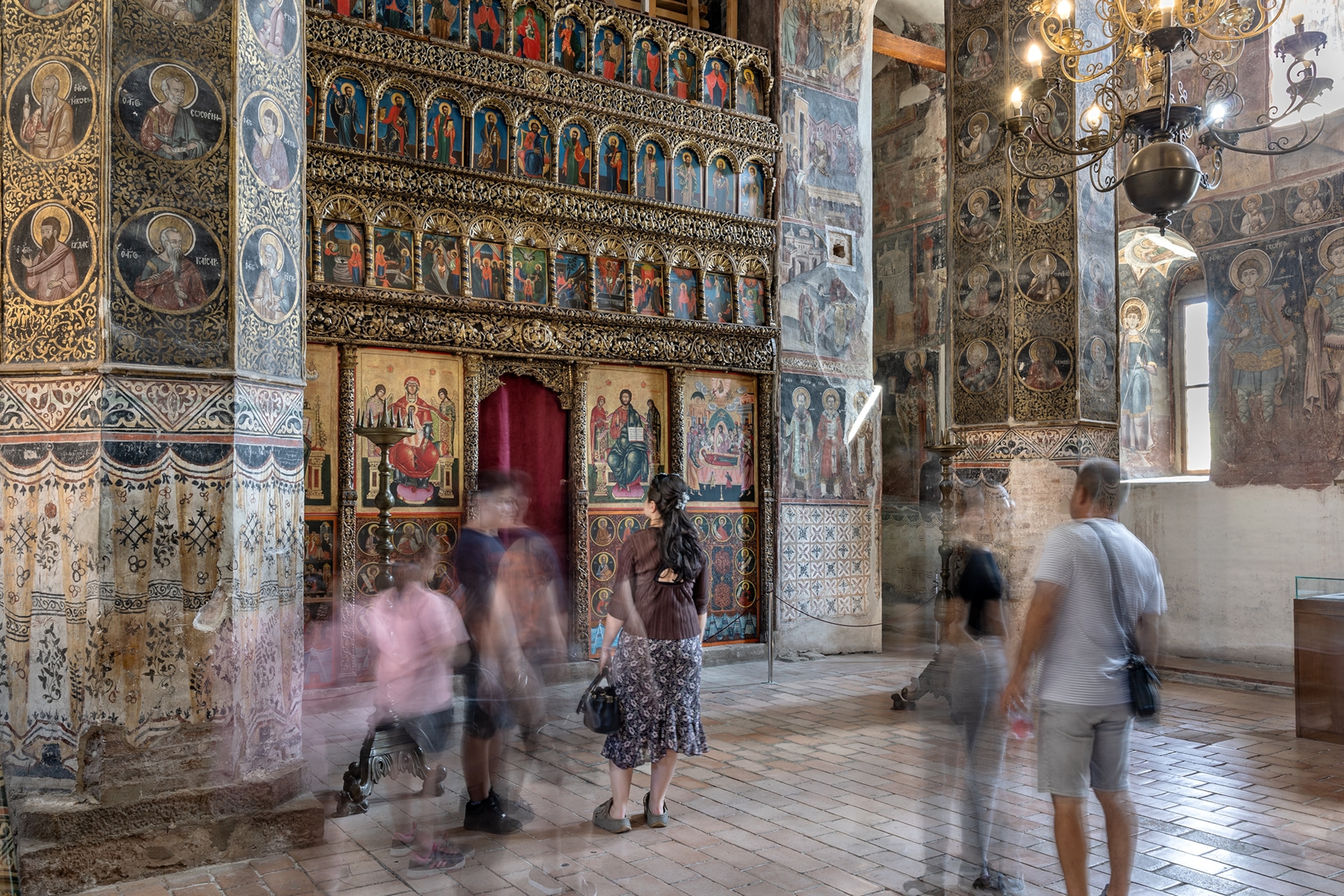 Visitors view elaborate designs and paintings in the Biserica Domnească (The Princely Church).