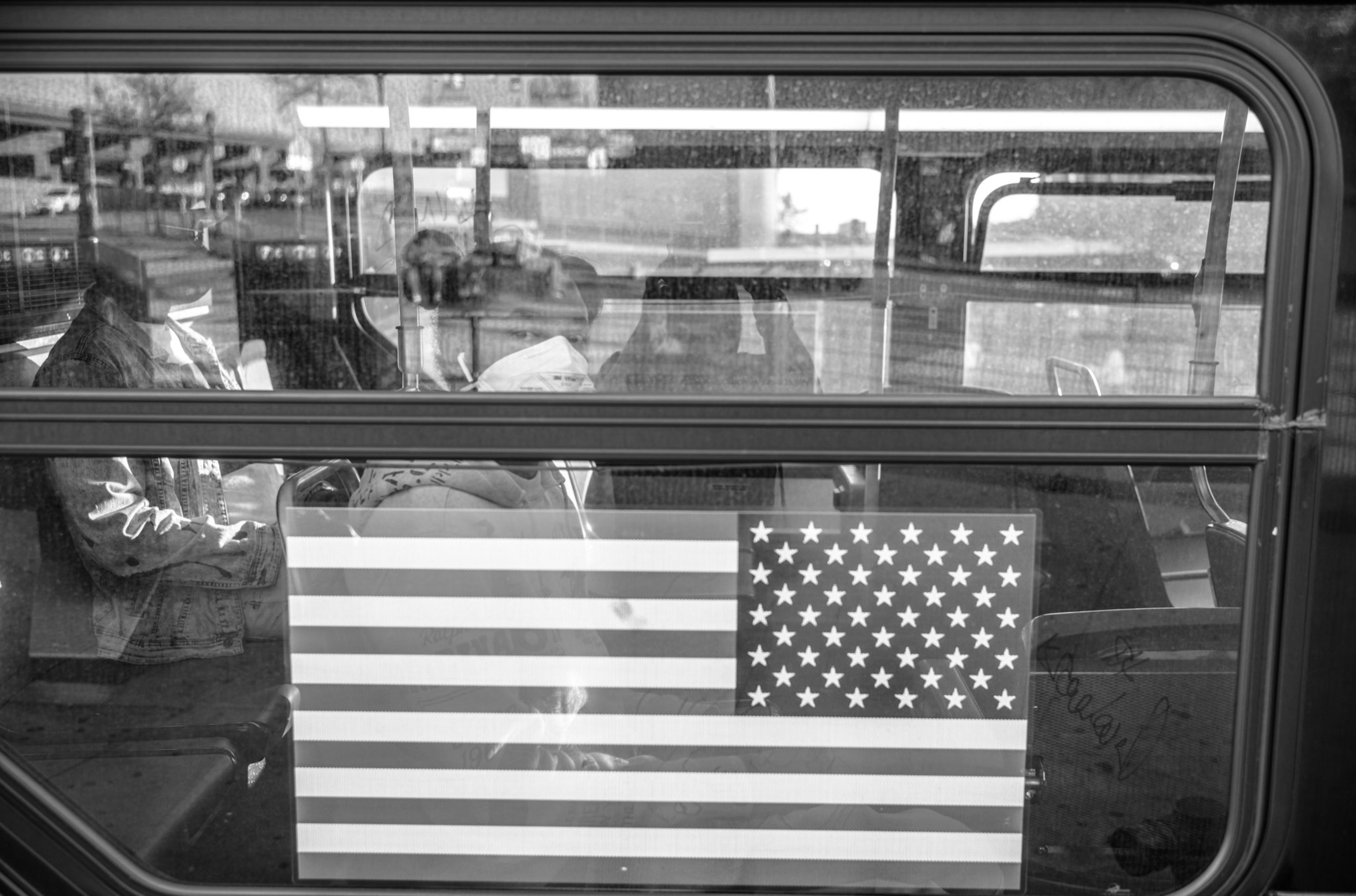 the exterior of a subway window with an American flag sticker on it