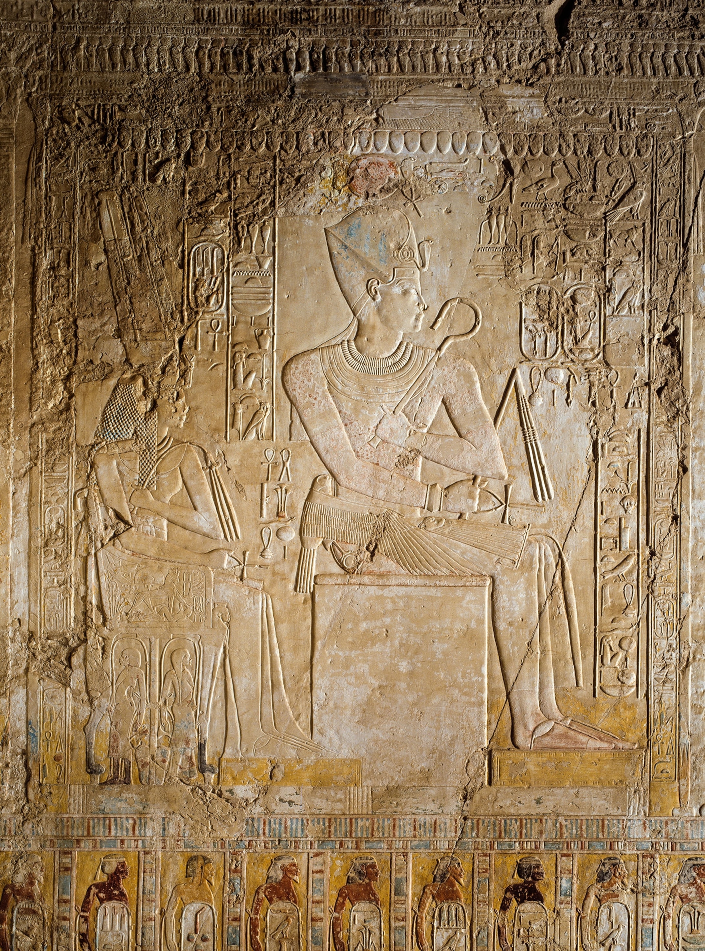 A stone relief of a pharaoh and his wife