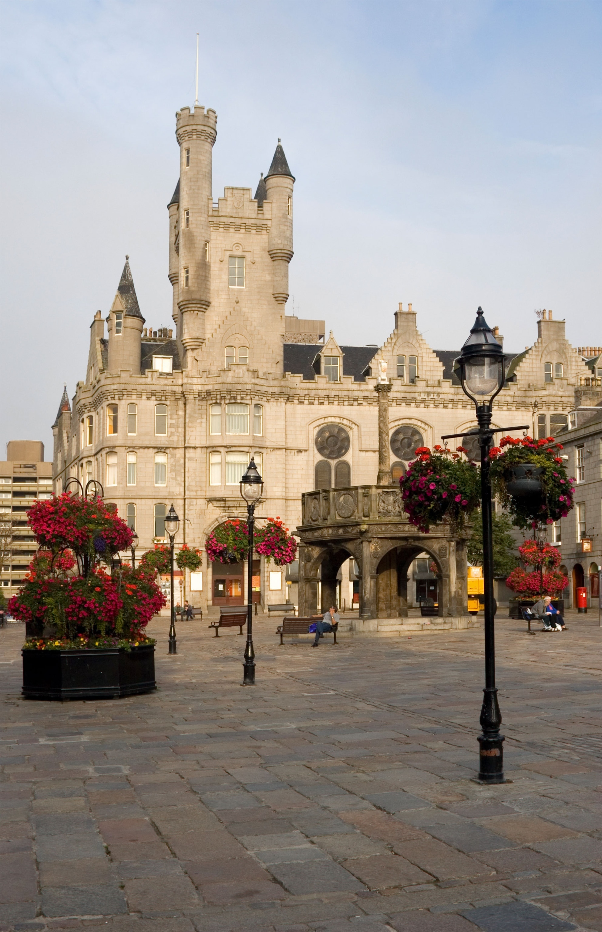 granite buildings lined by pockets of red flora