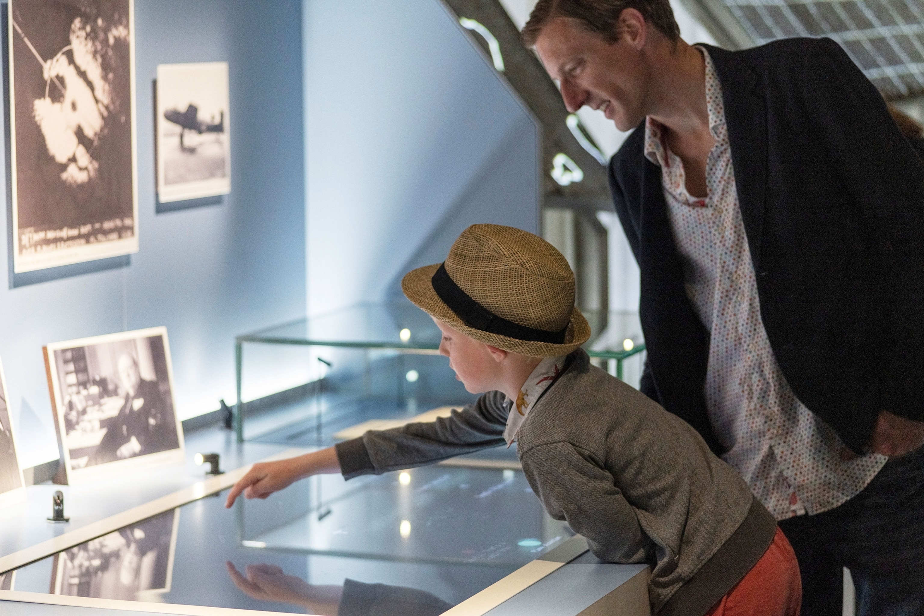 child and adult looking at viewing frames in museum