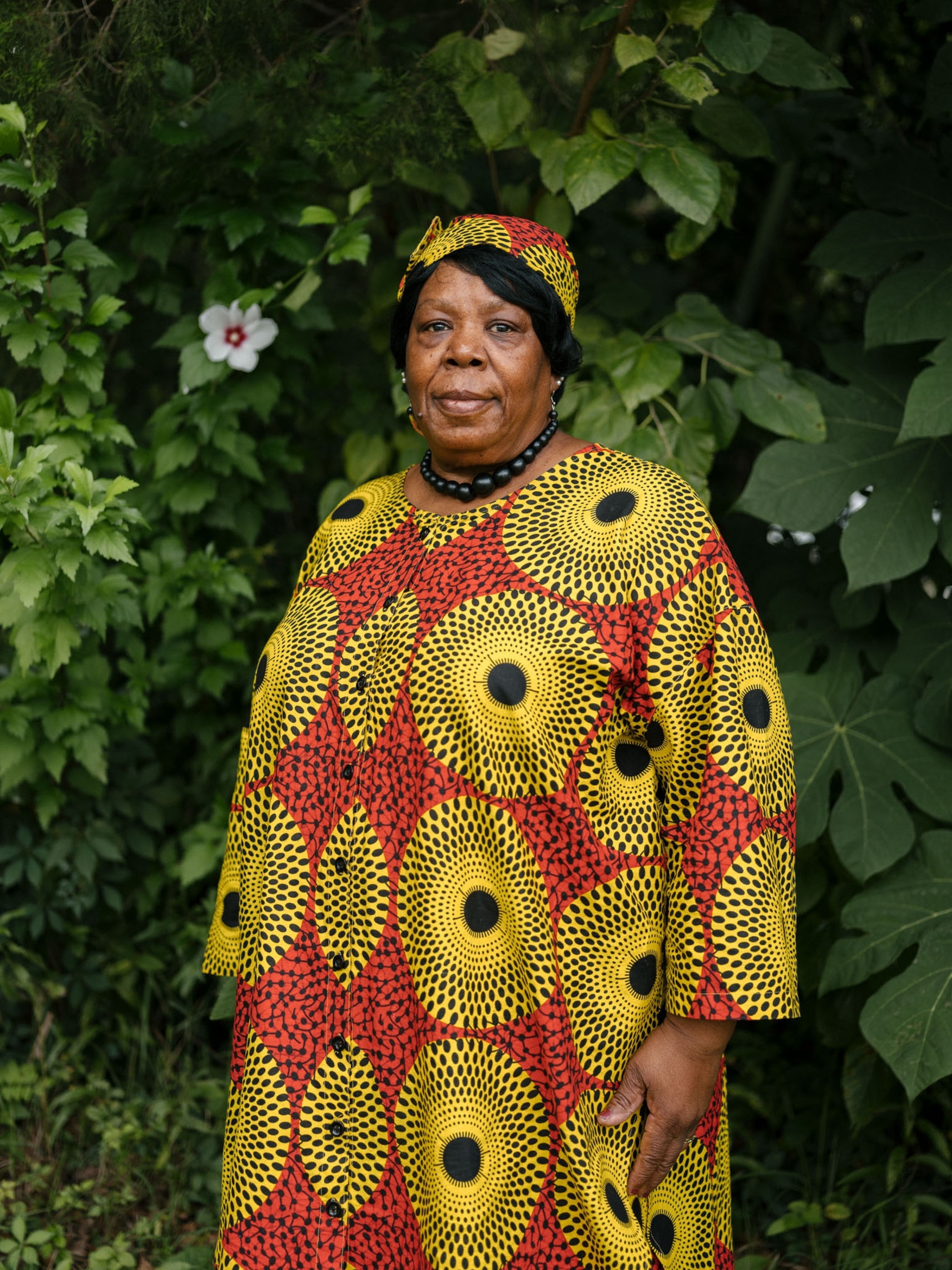 a woman standing for a portrait wearing traditional clothes