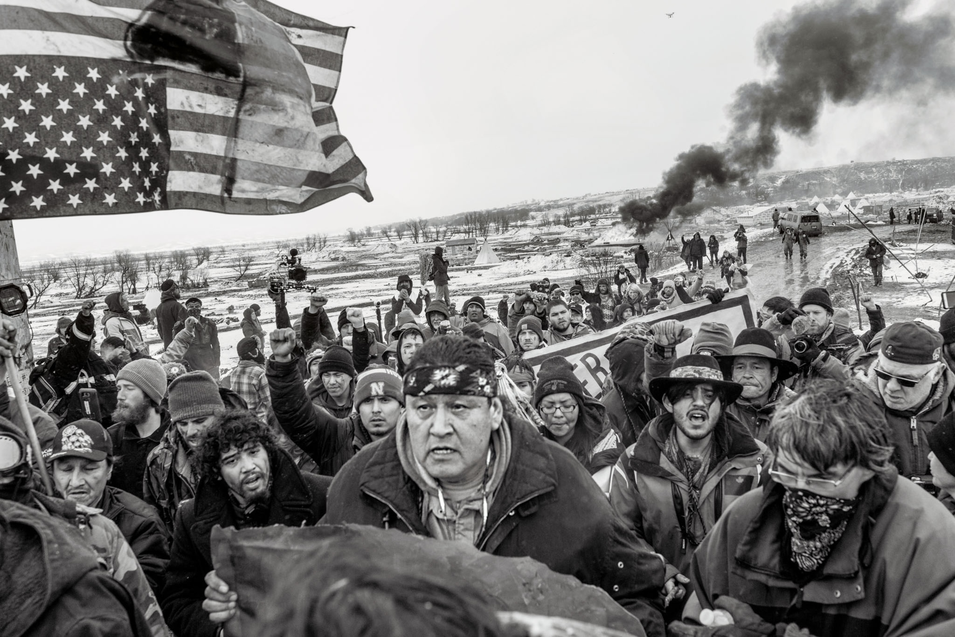 a black and white image of people protesting and marching