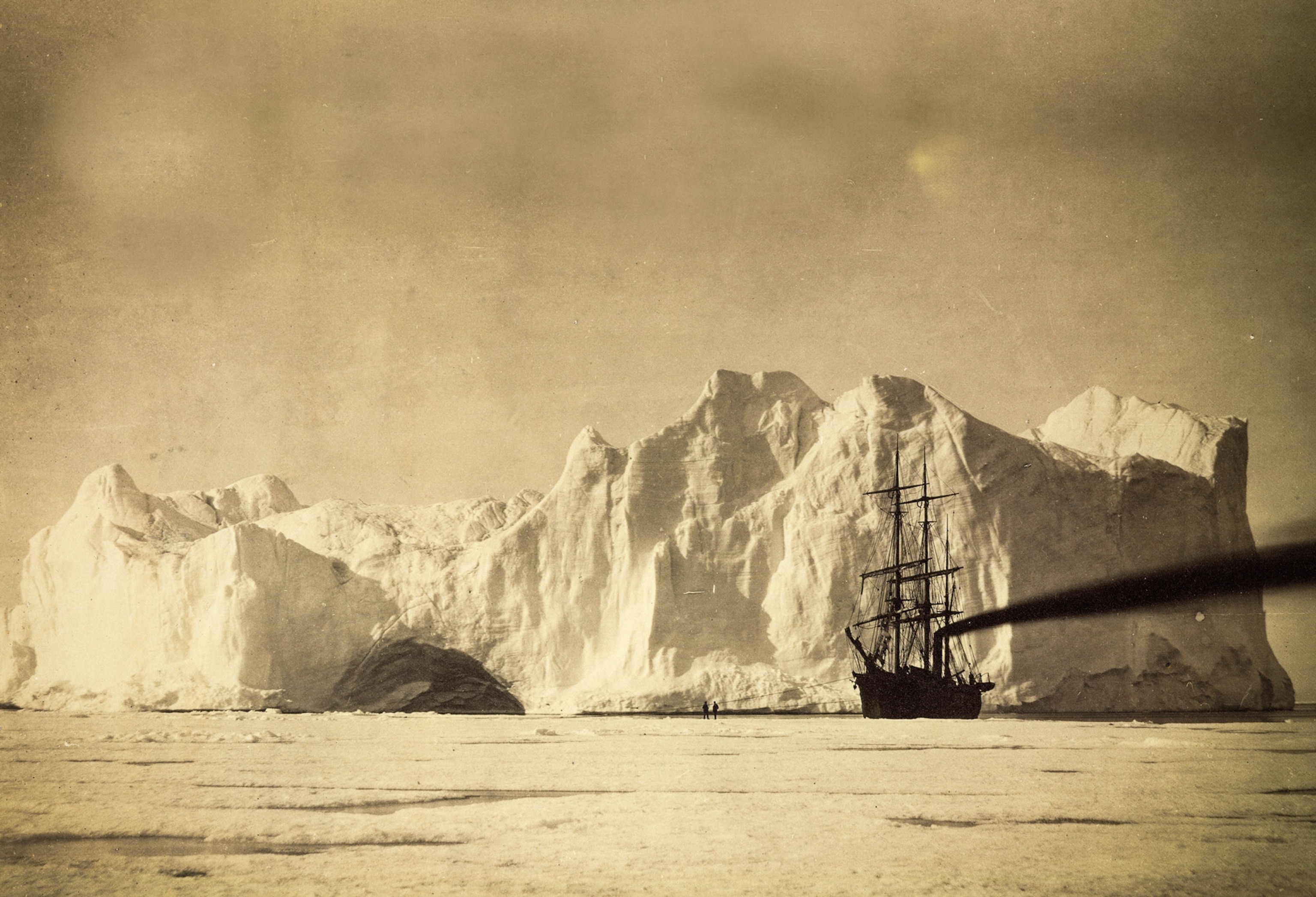 an iceberg looming over the Panther during an 1869 expedition to Greenland
