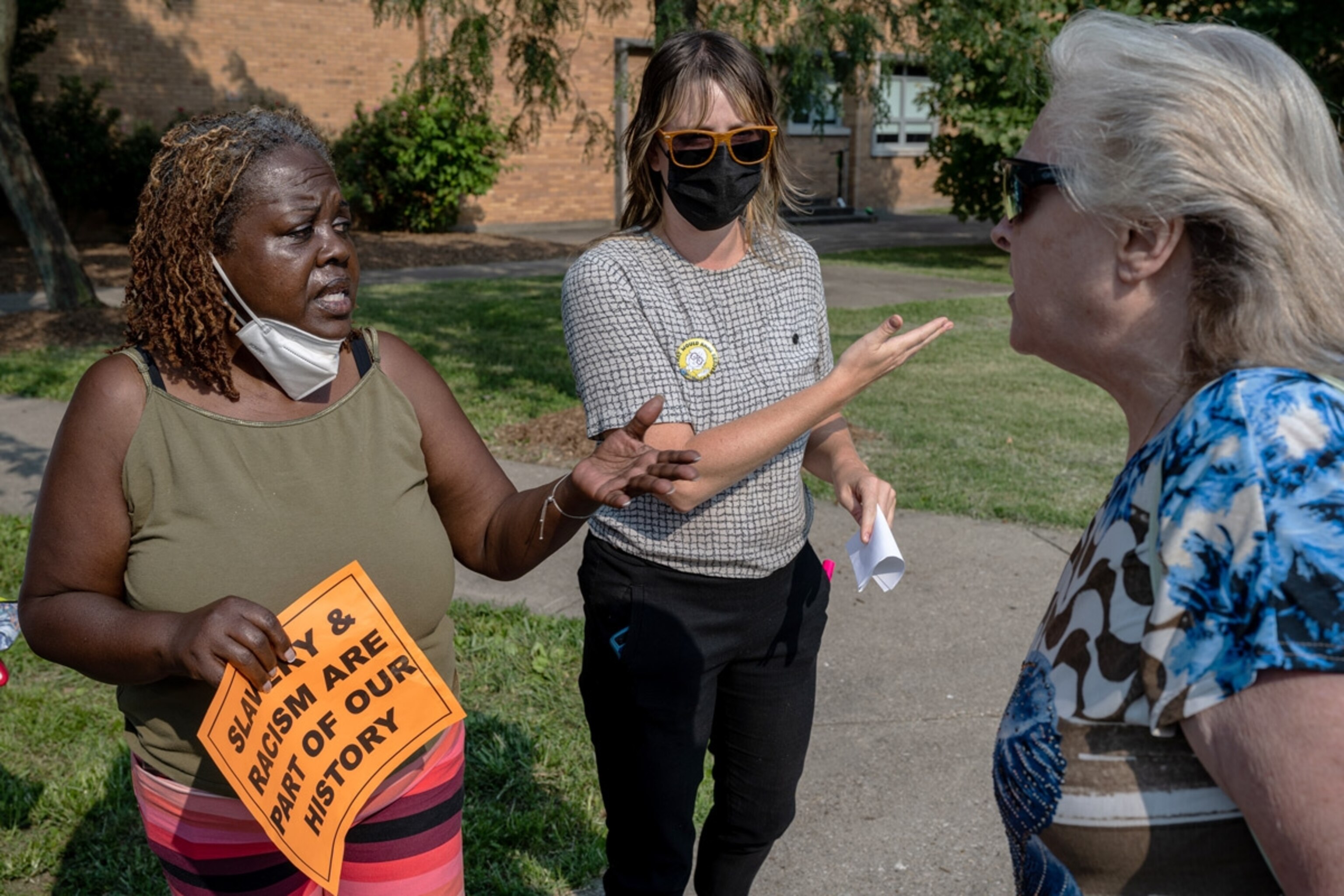 Demonstrators argue during a protest against what some call "critical race theory" before a school board meeting in Louisville, Kentucky, on July 27.