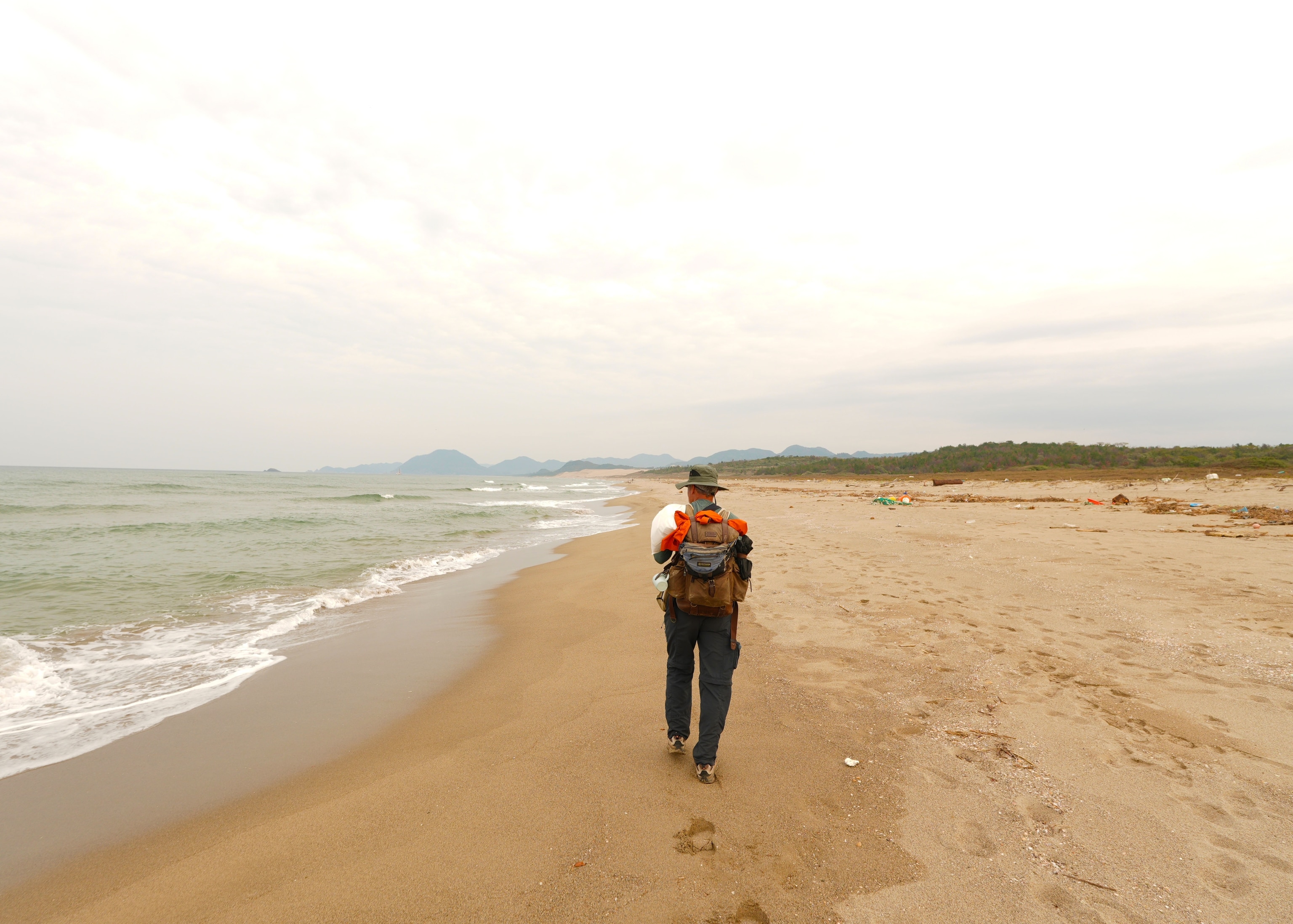 Salopek makes stride across Japan’s Hakuto Beach in November of 2024. It is the last country he’ll walk through in Asia before embarking on a cargo ship journey toward North America.