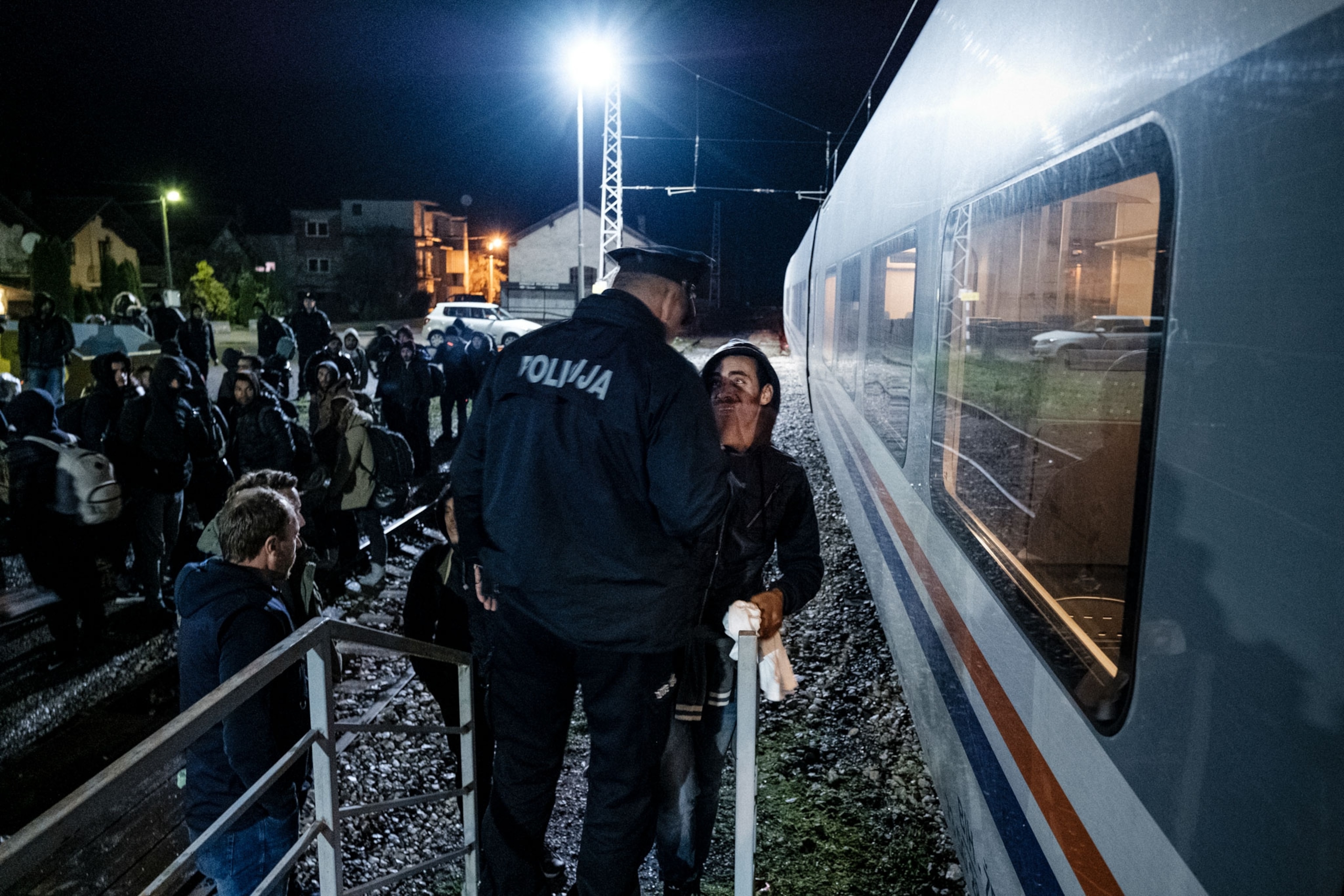 a migrant being confronted by a police officer in Bosnia