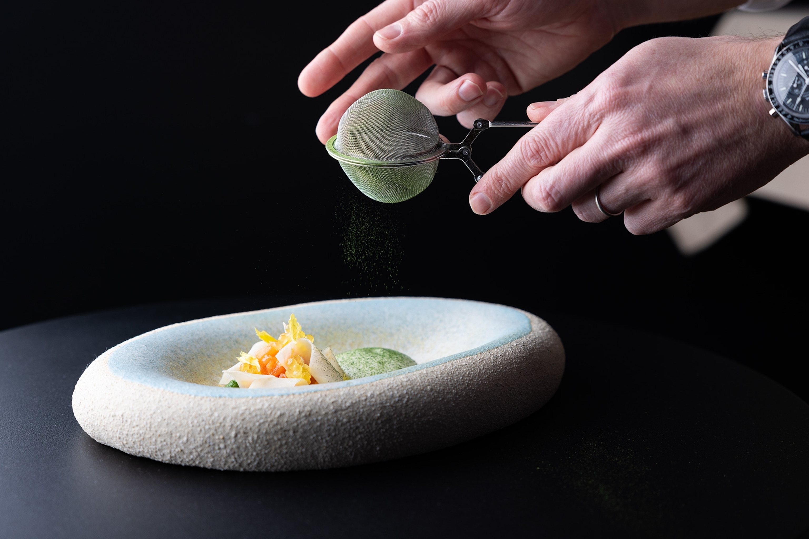 A dish of Char, Char caviar, Horseradish, & Spinach is prepared at the Krone Saumereiam Inn.