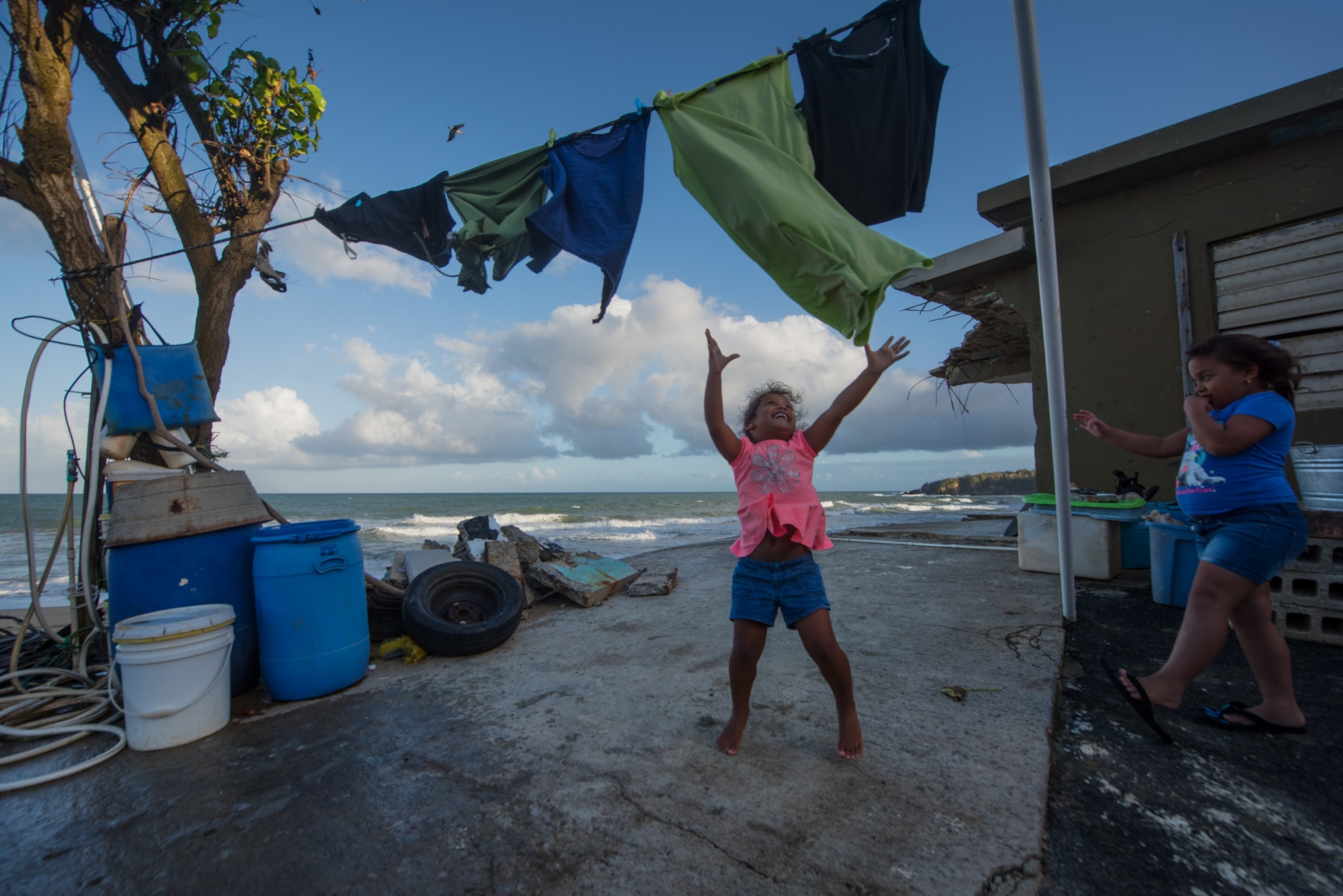 Berenanda Martinez playing with laundry at her grandmother's home