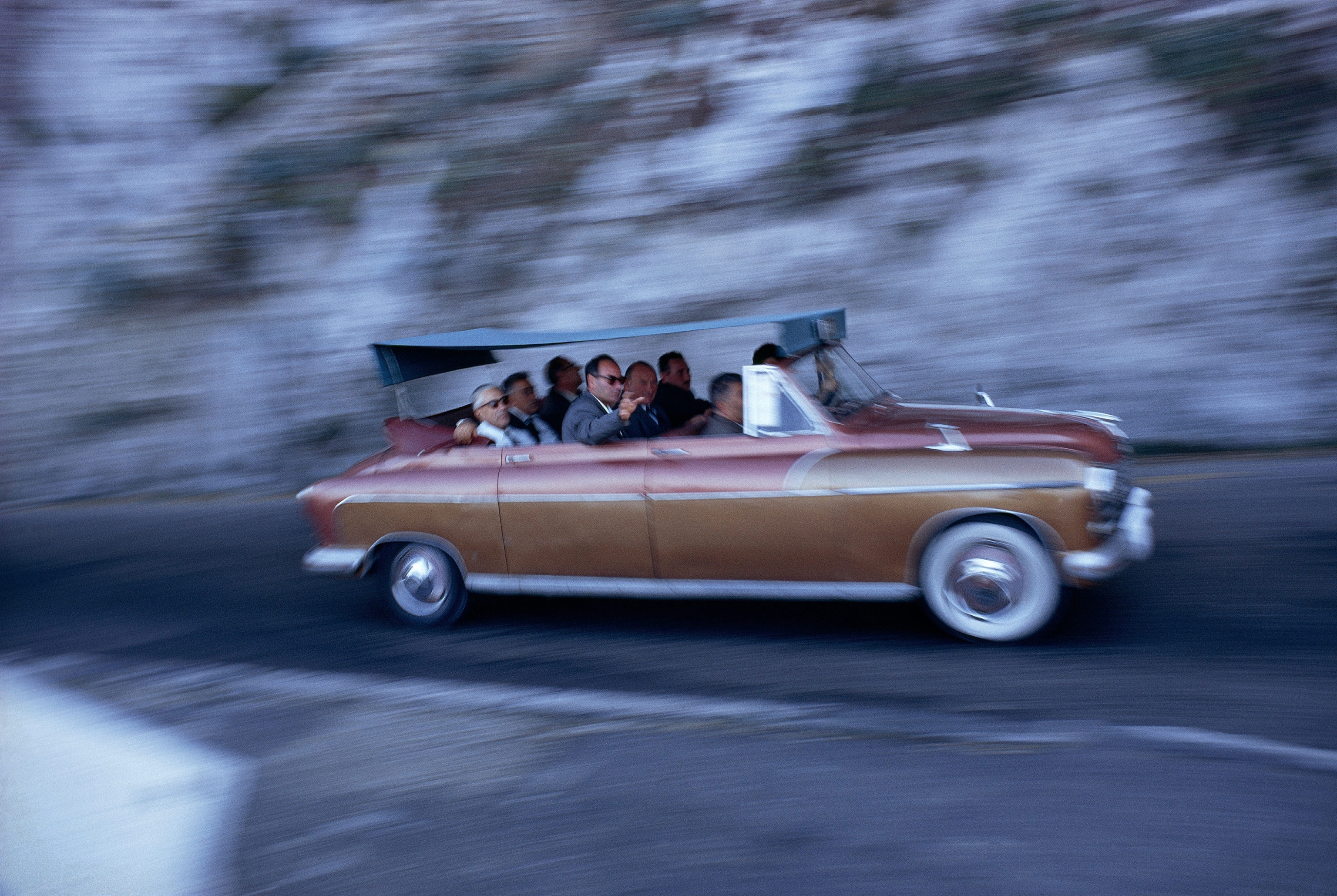 a crowded covered convertible driving to Anacapri in Capri Island, Italy