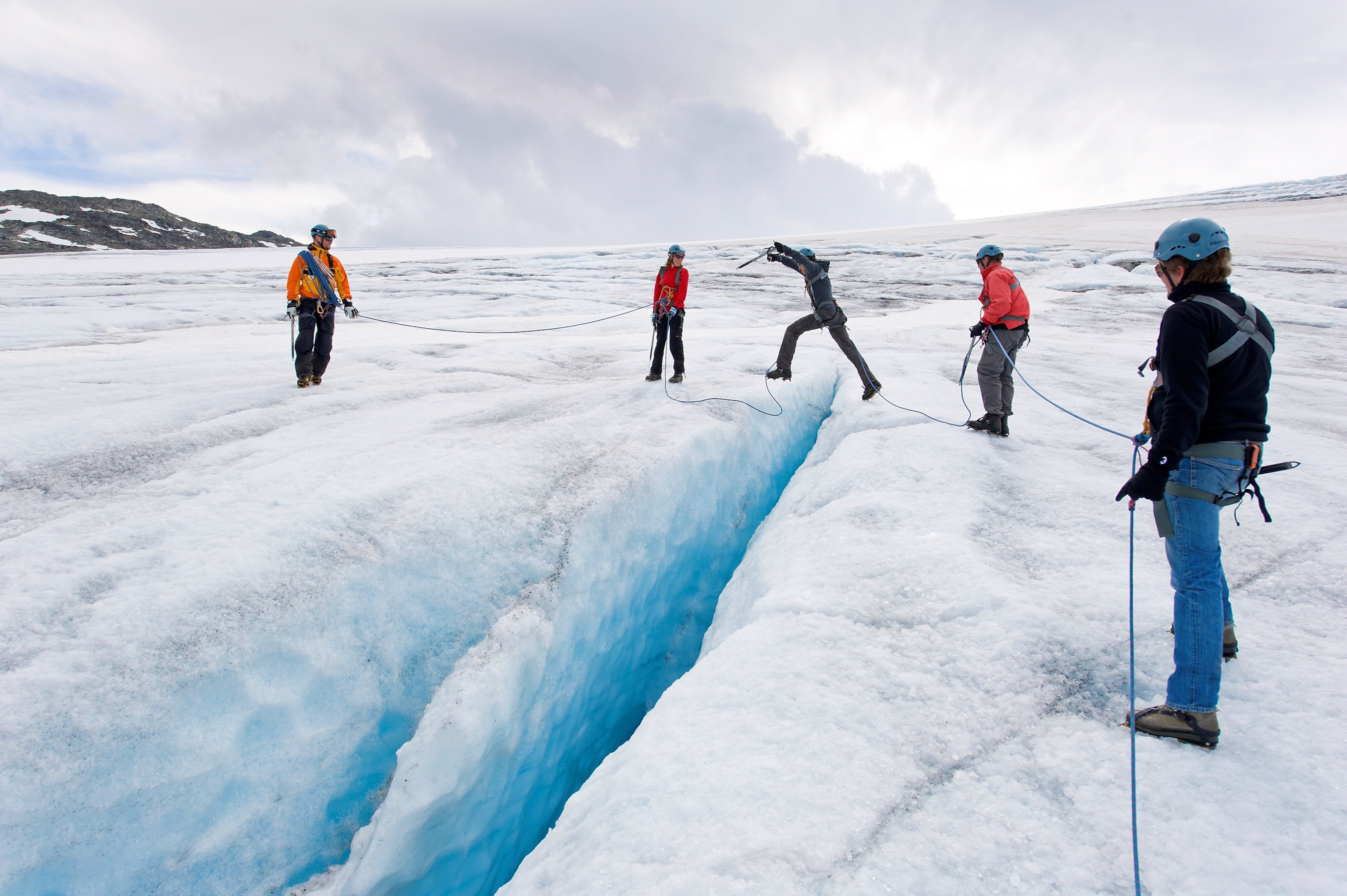 tourists hiking on the Hardangerjøkulen Glacier in Norway
