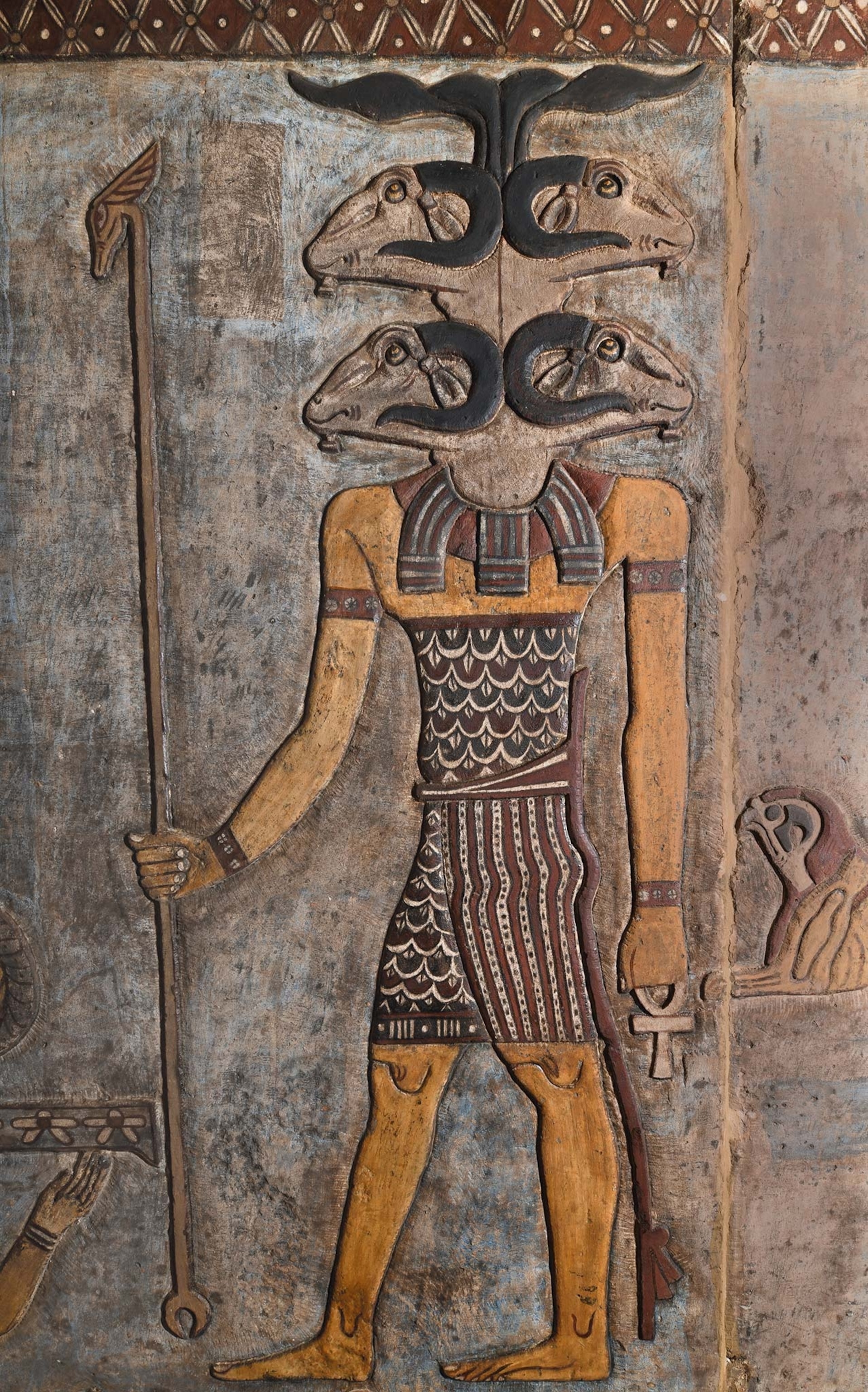 the restored and uncovered carving of a god with four rams heads