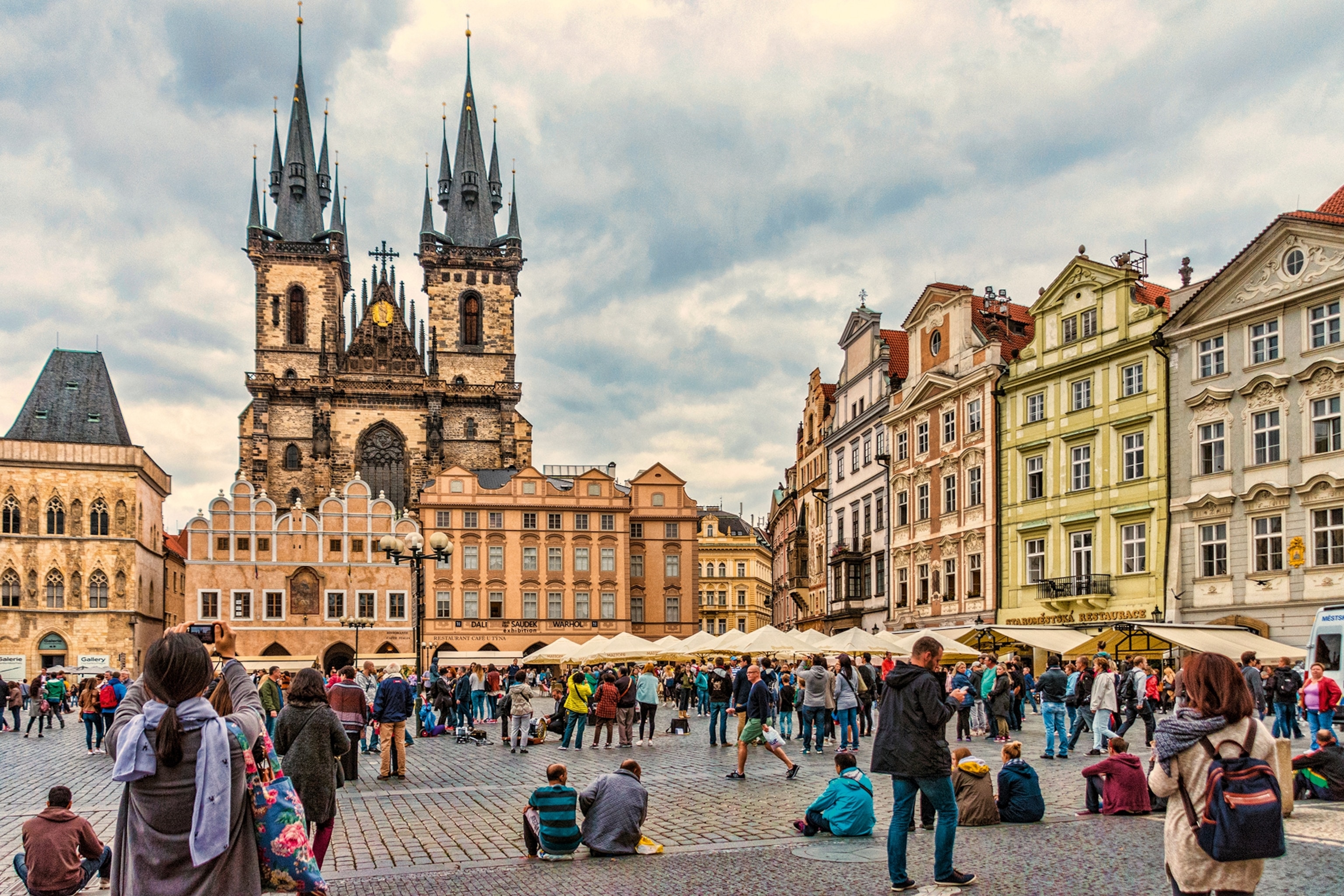 A main square in a European town, Prague, with cobblestone streets and old style buildings.