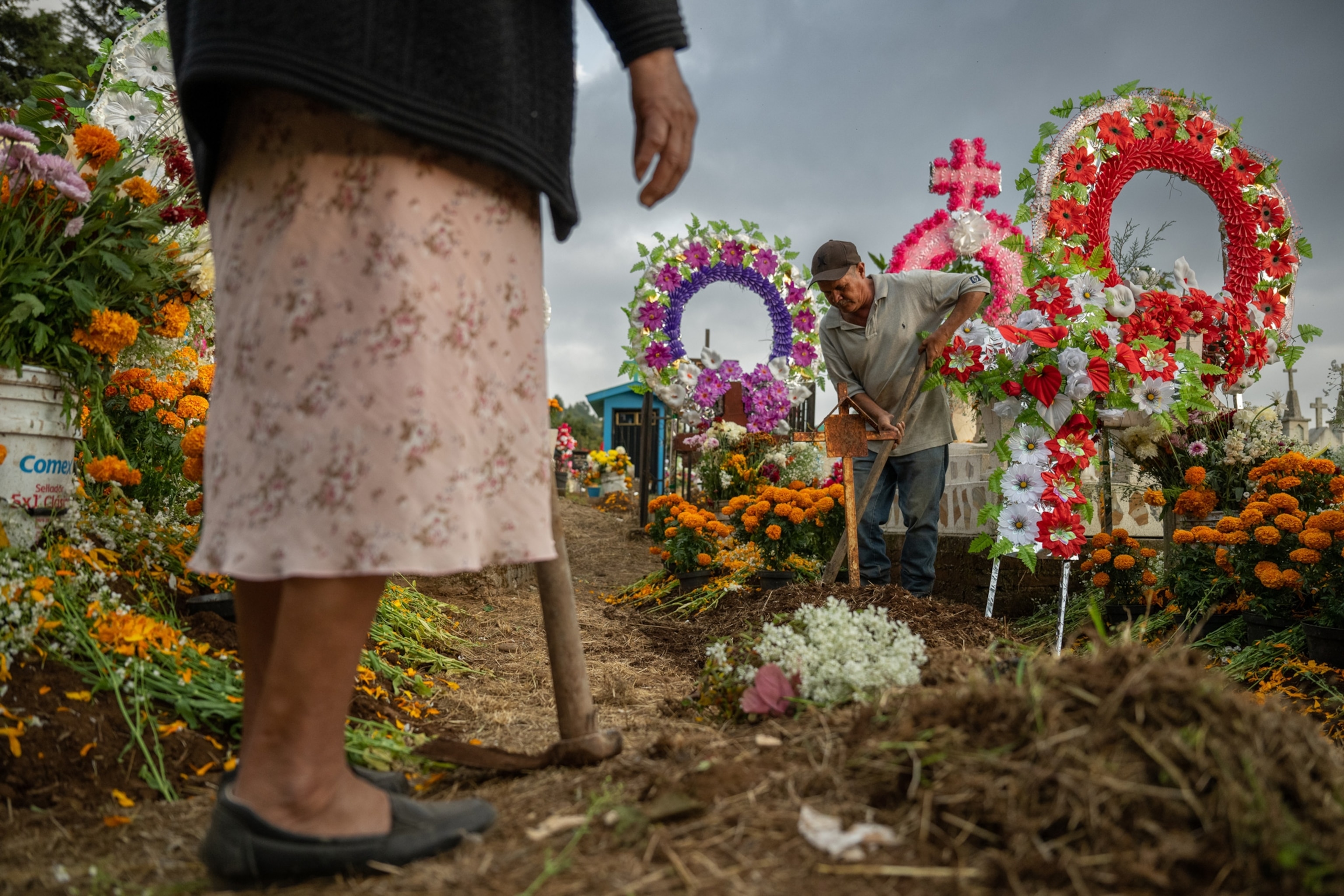 Cleaning tomb in graveyard for day of the dead celebration in mexico.