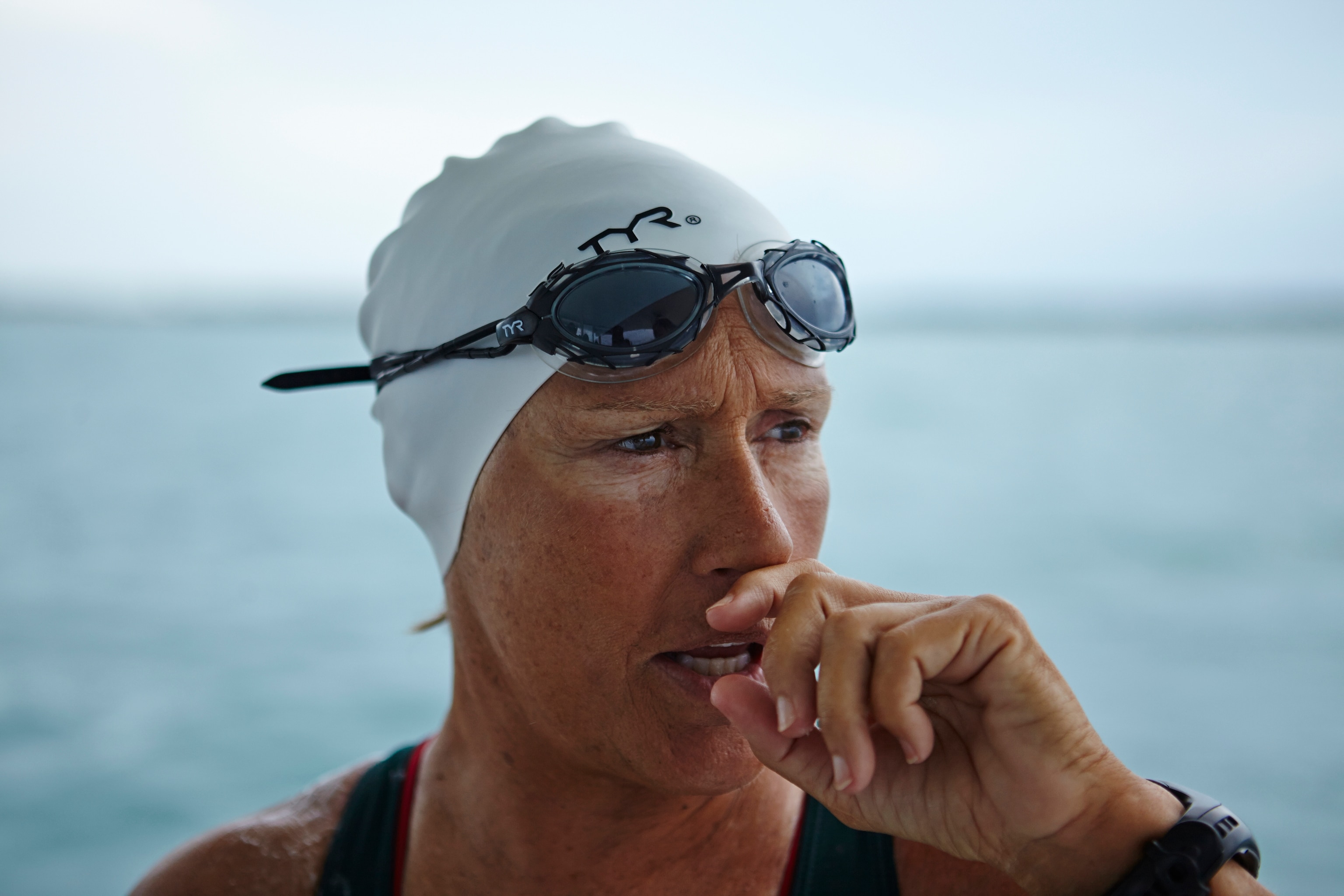 a portrait of a swimmer looking out over the water