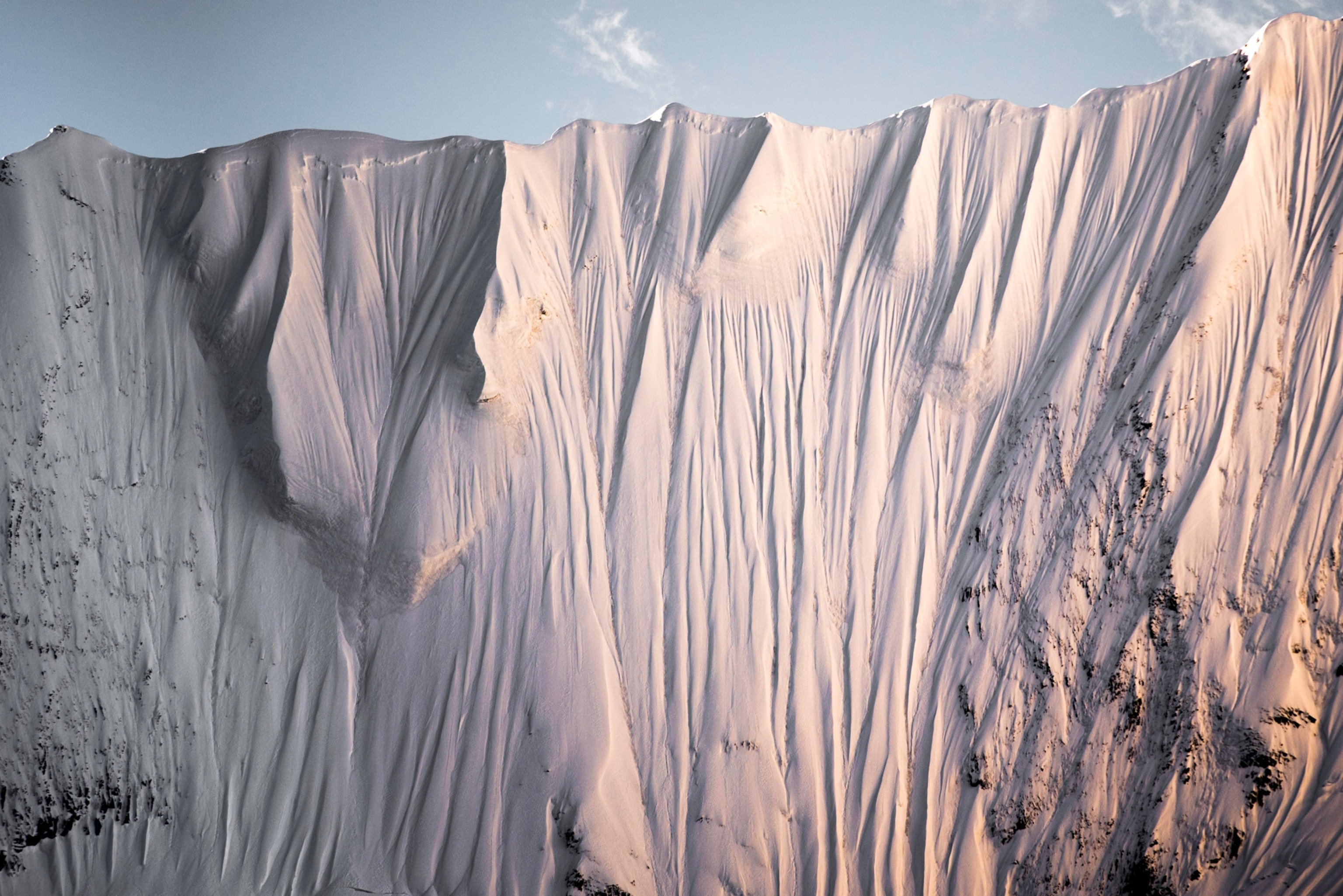 Photo of tall mountain face against sky