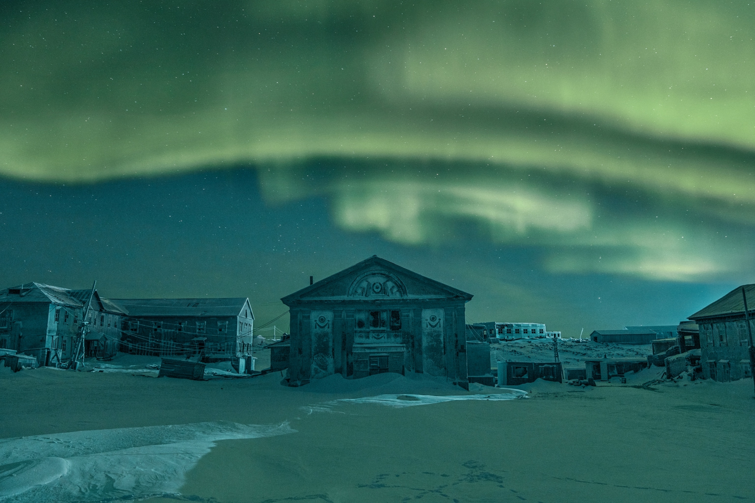 aurora borealis over buildings.