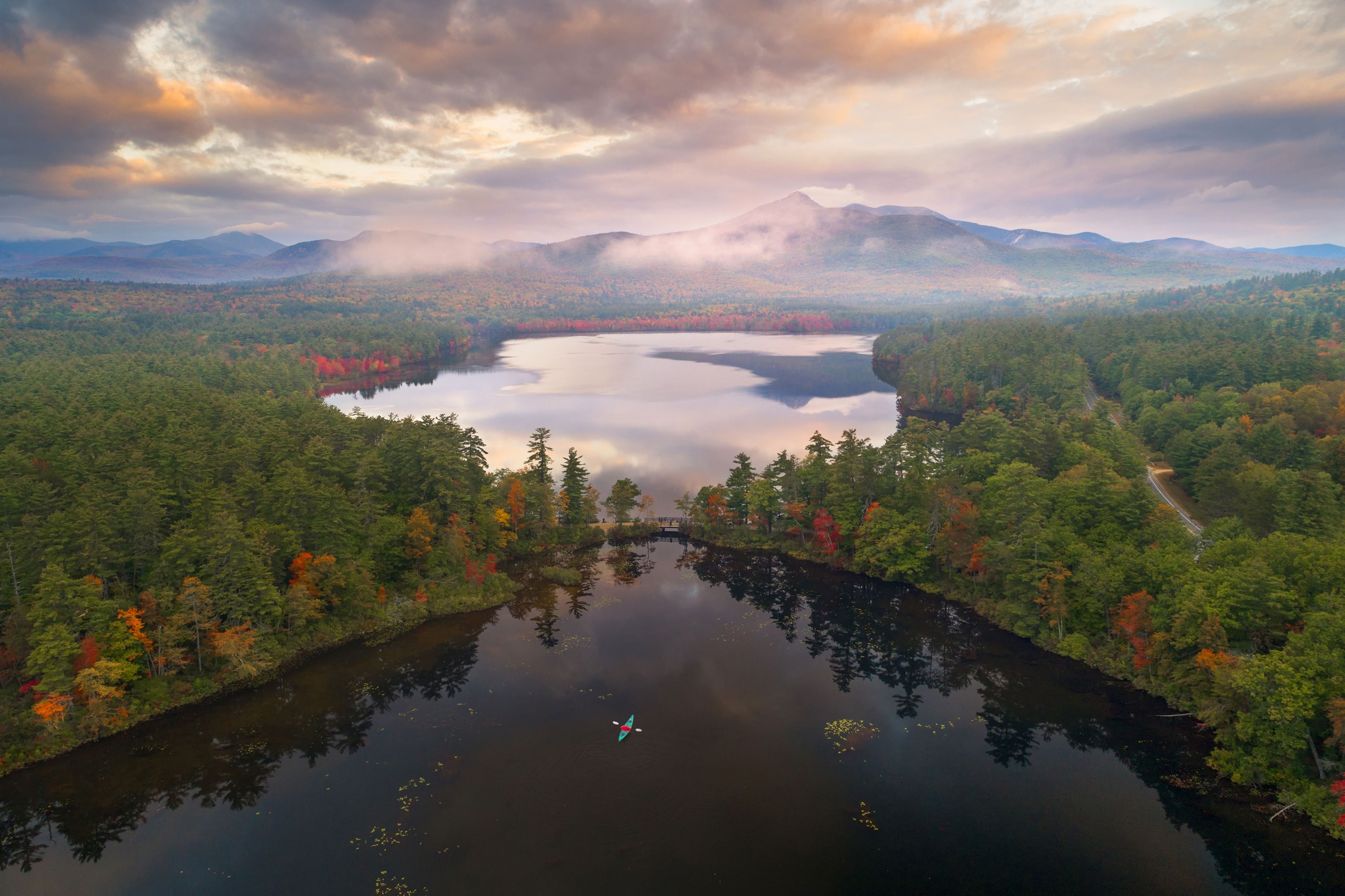 a kayaker enjoying the sunrise at Chocorua lake, New Hampshire