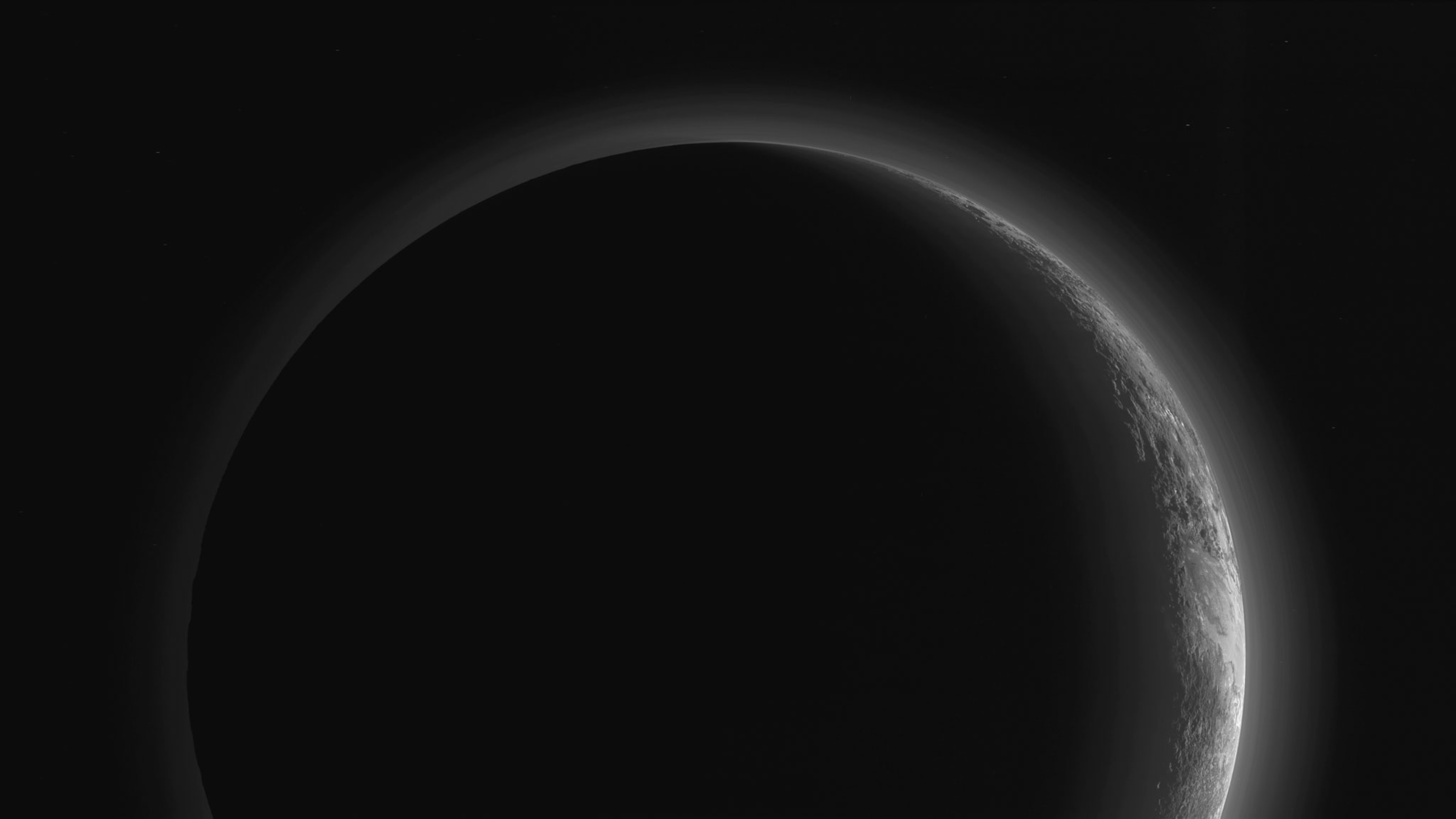 Pluto silhouetted against the sun