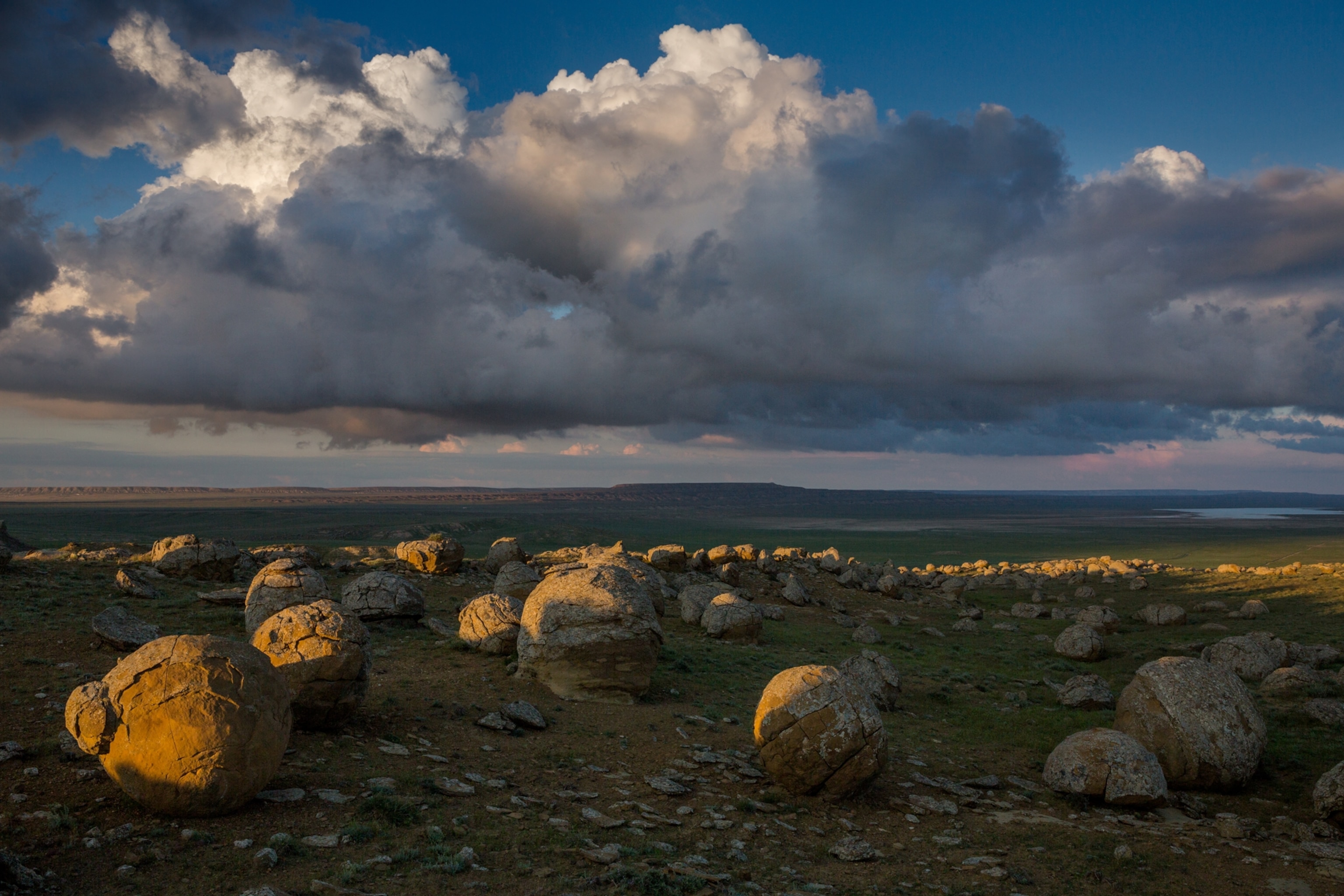 massive round rocks strewn across the steppes of western Kazakhstan in the evening light