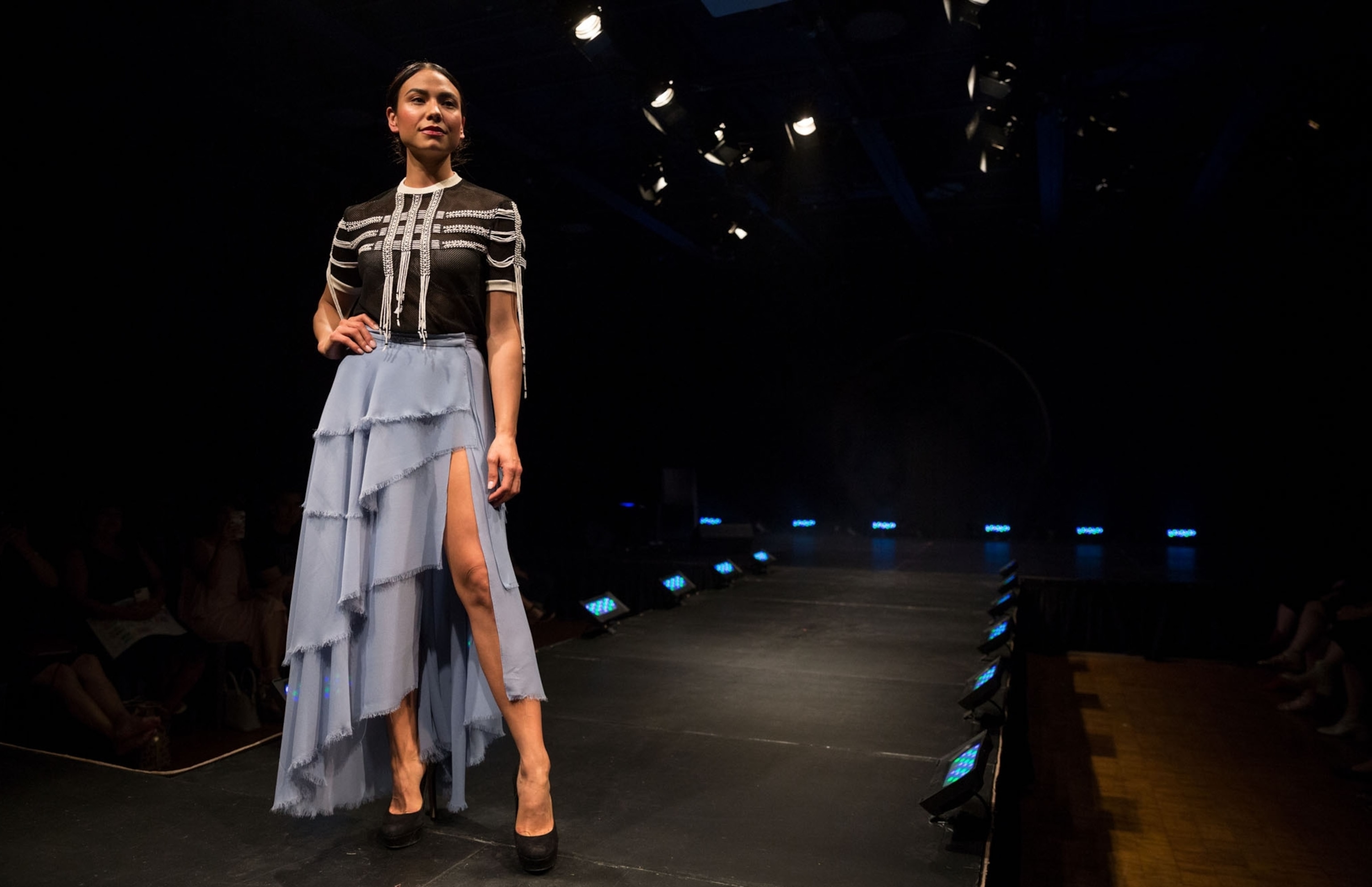 a model standing in the end of a runway