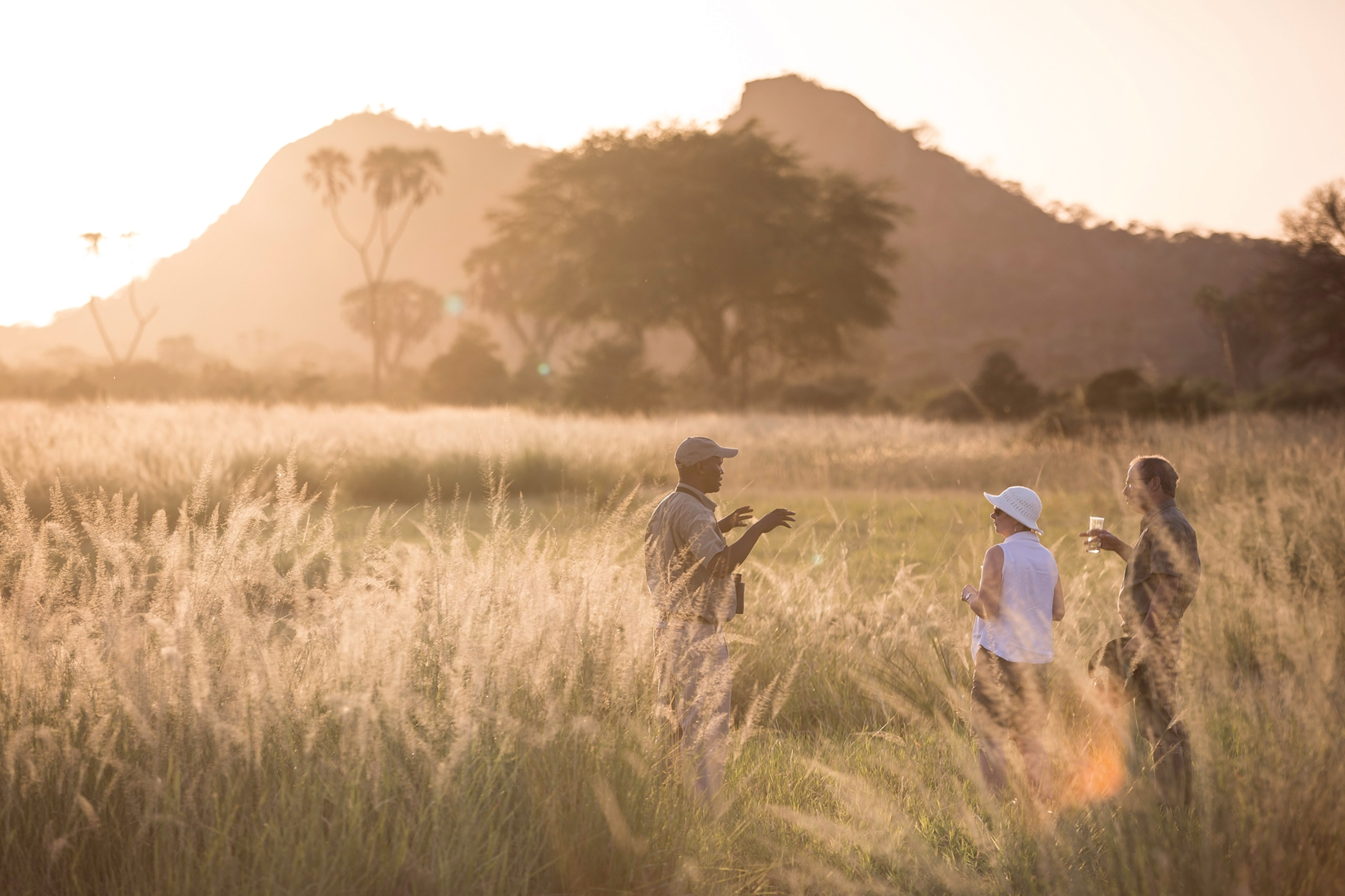 Three people enjoying the sunset in Meru National Park.