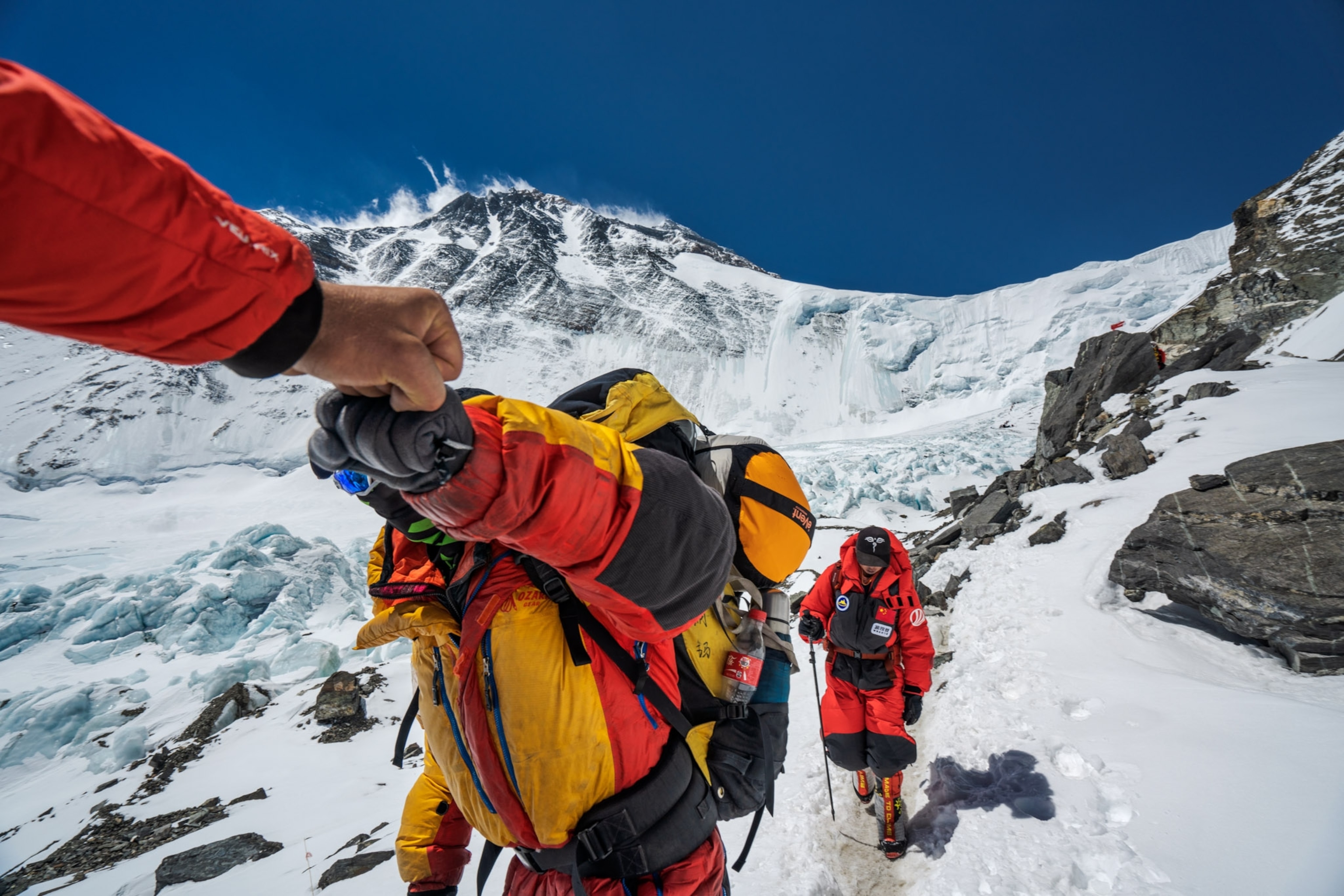 two climbers giving each other a fist bump