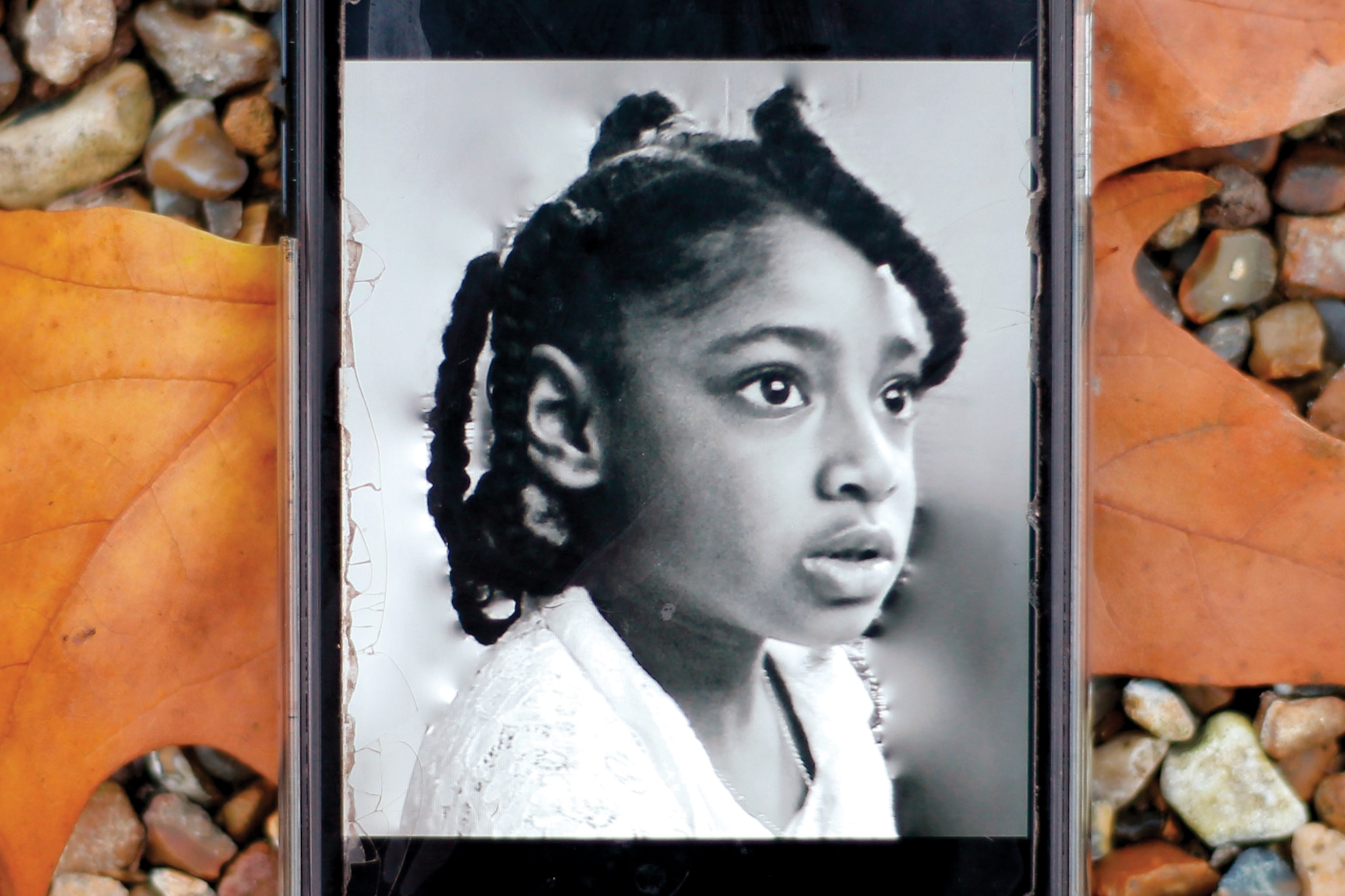 Picture of photograph or a girl on mobile phone.